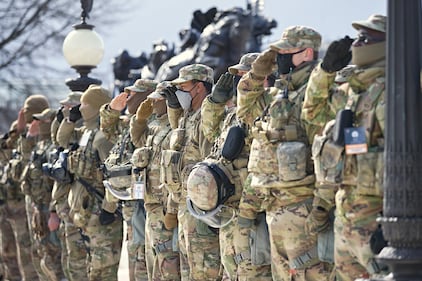 U.S. soldiers and airmen of the National Guard salute the presentation of the colors during the inauguration ceremony on Jan. 20, 2021, in Washington.