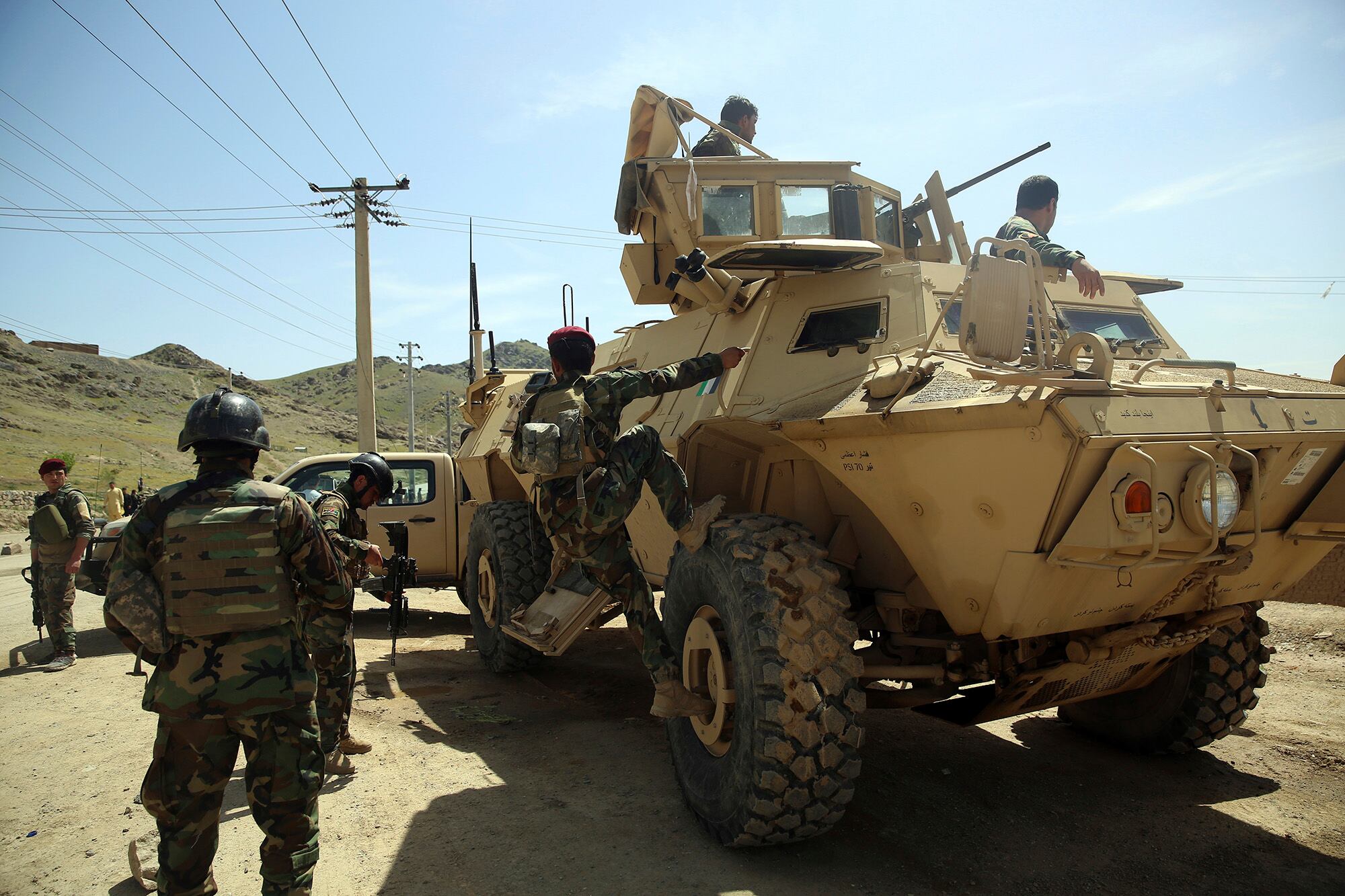 In this April 29, 2020, file photo, Afghan special forces stand guard at the site of a suicide bomber attack on the outskirts of Kabul, Afghanistan.