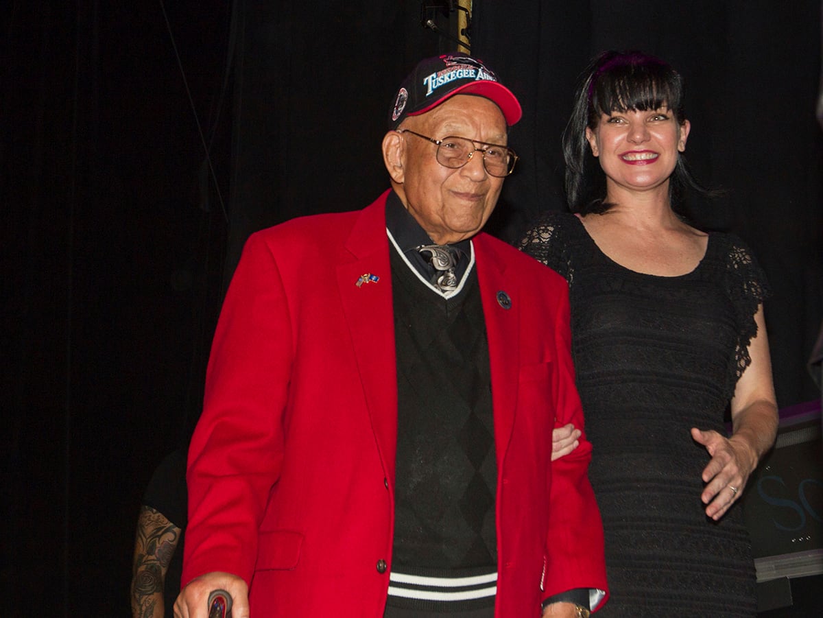 actress Pauley Perrette, right, and Lt. Col. Bob Friend, a Tuskegee Airman, stand onstage during the 2nd Annual Heroes Helping Heroes Benefit Concert