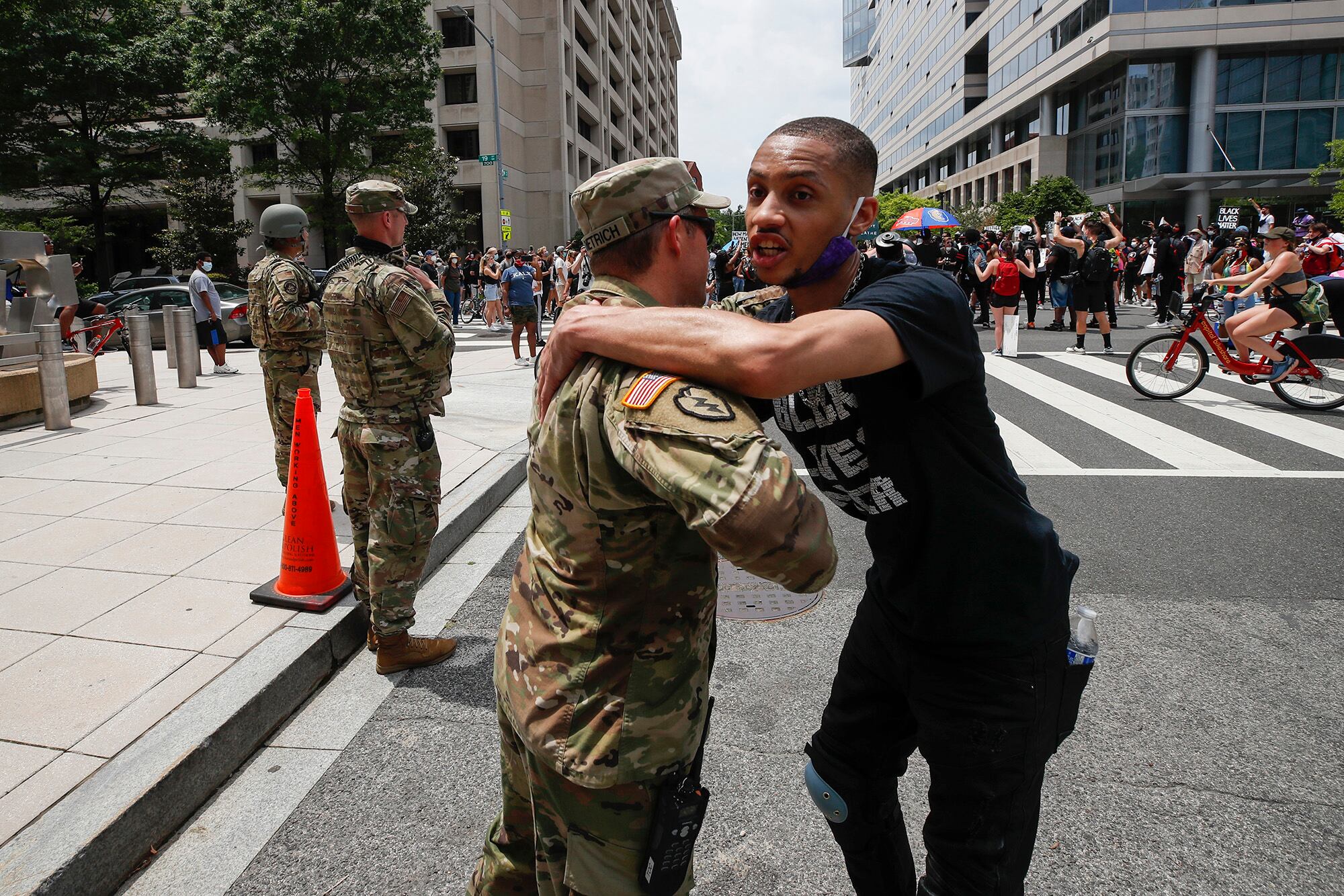 In this June 6, 2020, file photo, a demonstrator hugs a National Guard soldier during a protest in Washington, over the death of George Floyd, a black man who was in police custody in Minneapolis.