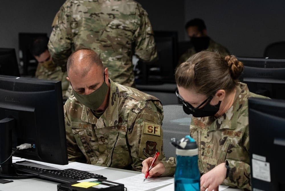 Chief Master Sgt. Robert Plant, 919th Special Operations Security Forces Squadron superintendent, and Chief Master Sgt. Christina Bicknell, 919th Special Operations Mission Support Group chief, review an enlisted performance report during training for raters at Duke Field, Florida, April 9, 2021. (Senior Airman Dylan Gentile/Air Force)