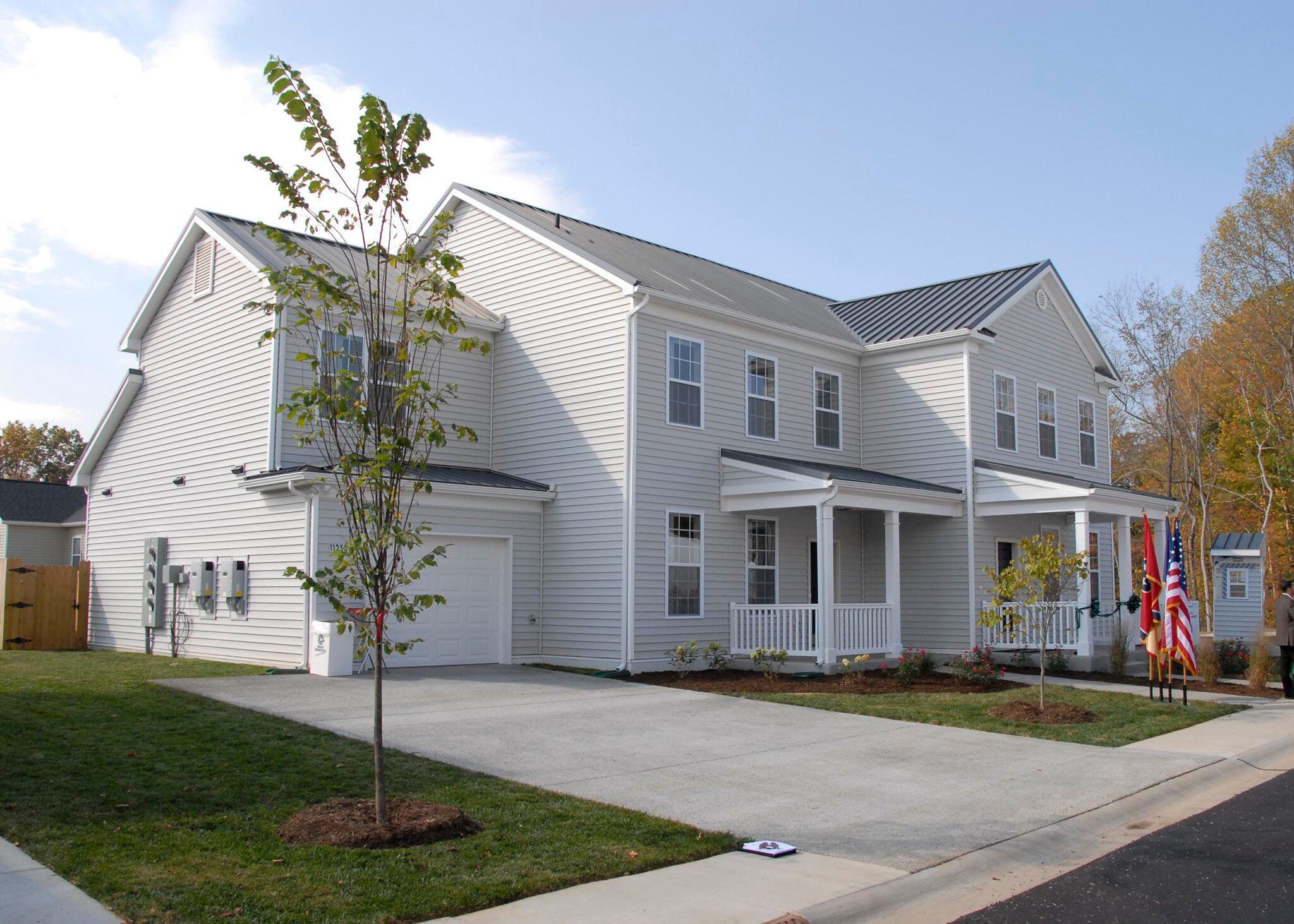 A ribbon-cutting ceremony takes place as Campbell Crossing celebrates the completion of the first two zero-energy homes on a military installation at Fort Campbell, Ky., in 2010.