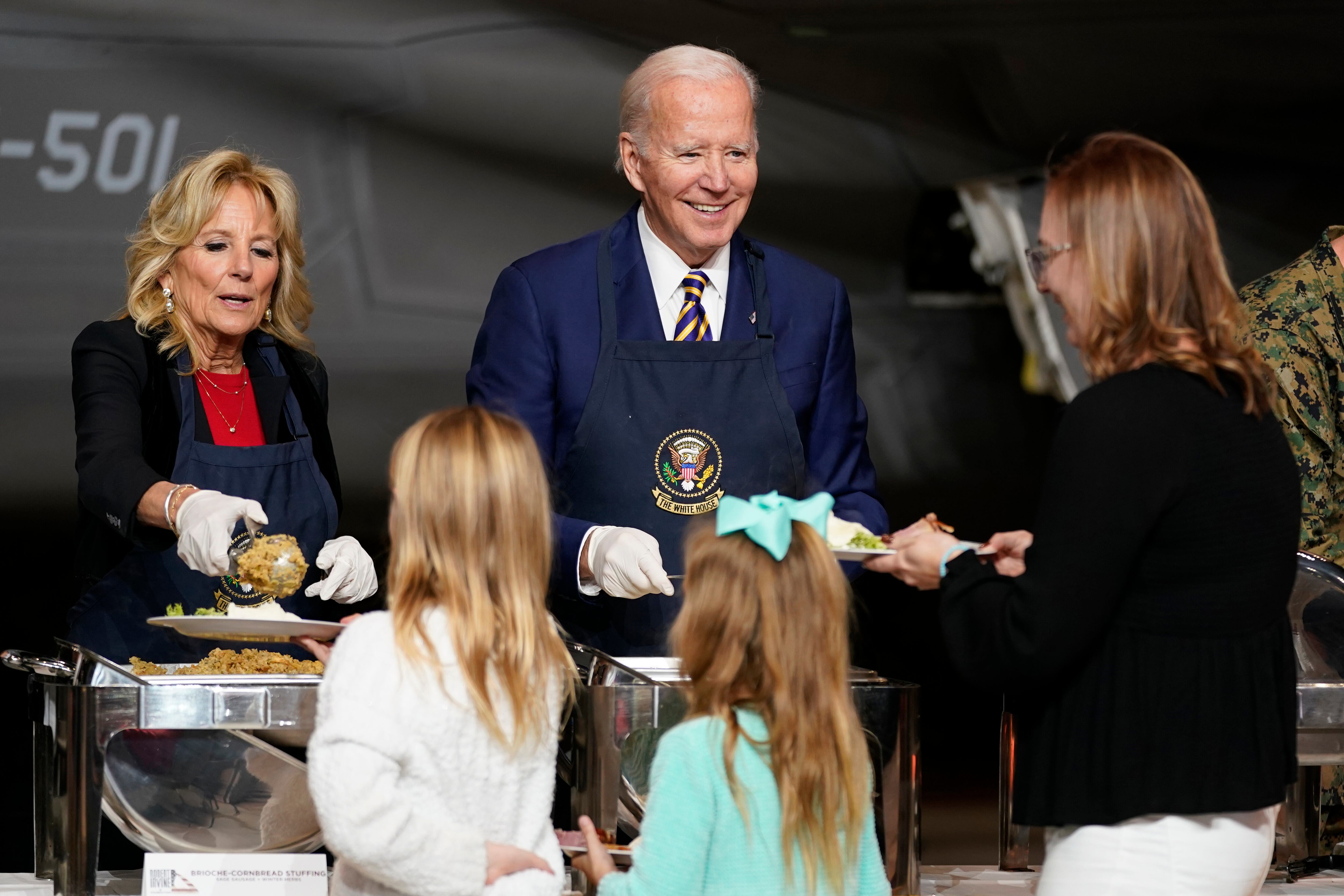 President Joe Biden and first lady Jill Biden serve dinner at Marine Corps Air Station Cherry Point in Havelock, N.C., Monday, Nov. 21, 2022, at a Thanksgiving dinner with members of the military and their families.