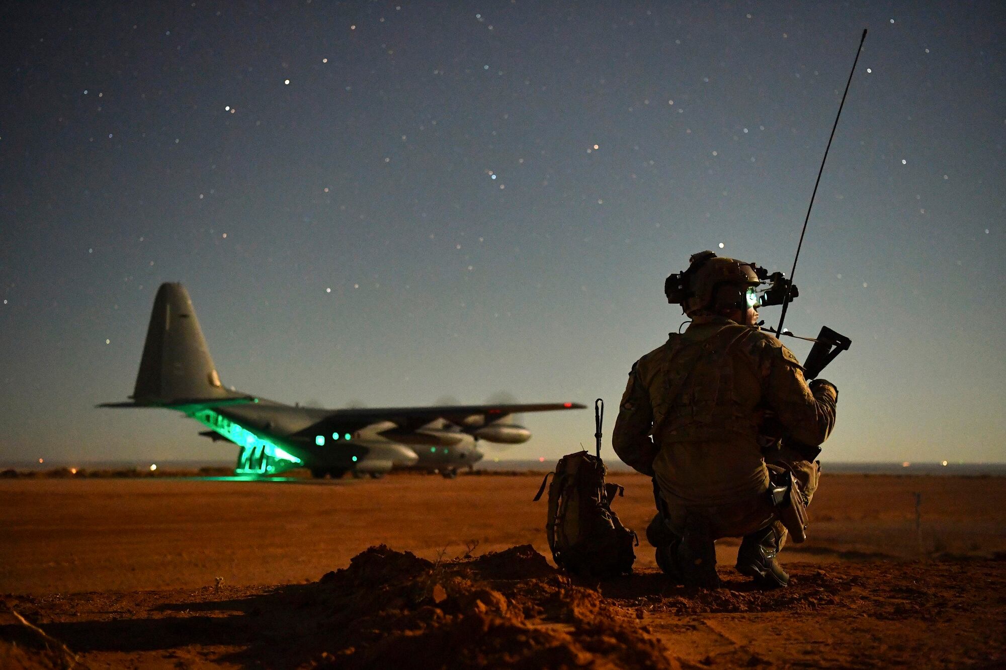 A Special Tactics operator guides a 27th Special Operations Wing MC-130J onto a runway during an exercise Nov. 6, 2020, at Melrose Air Force Range, N.M.