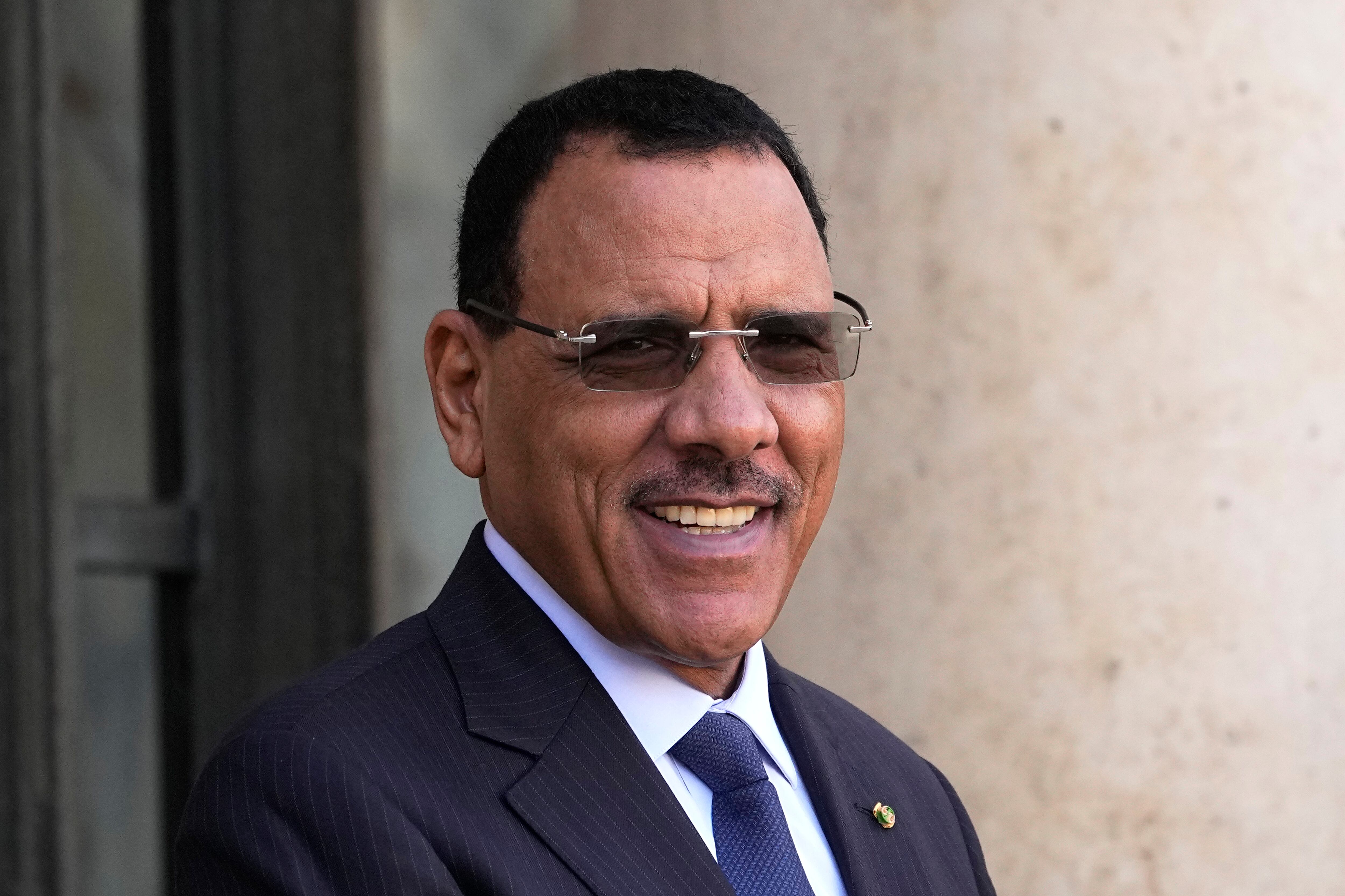 Niger's President Mohamed Bazoum smiles before a working lunch with French President Emmanuel Macron, Feb. 16, 2023 at the Elysee Palace in Paris.