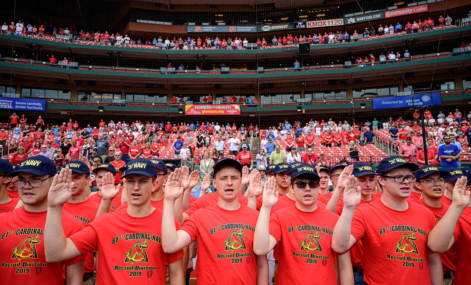 Eighty-one recruits with the 61st Annual Recruit Cardinal Division recite the oath of enlistment at Busch Stadium during a pre-game ceremony, June 6, 2019, in St. Louis.