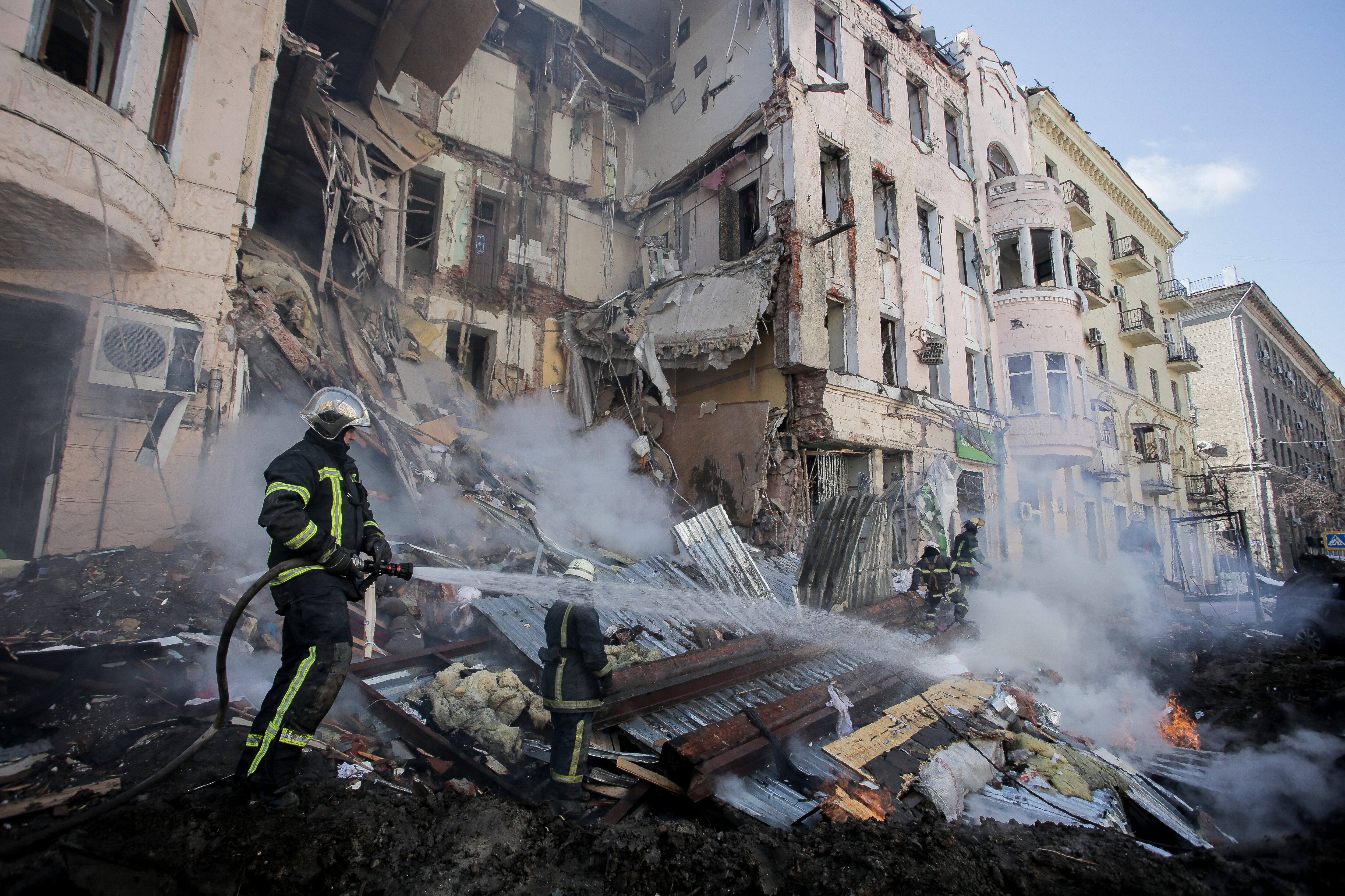 Firefighters extinguish an apartment house after a Russian rocket attack in Kharkiv, Ukraine's second-largest city, Ukraine, Monday, March 14, 2022. (AP Photo/Pavel Dorogoy)