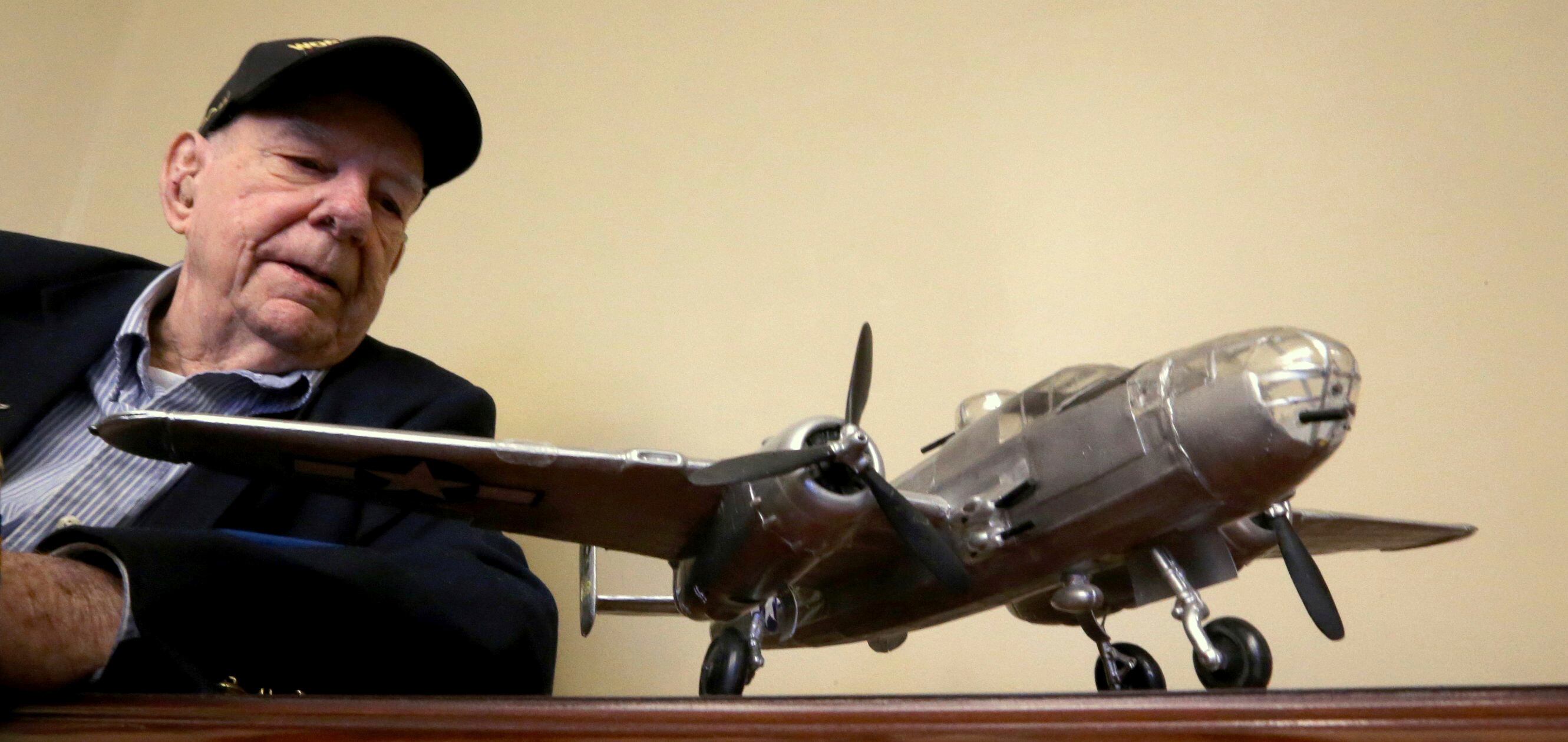 Former WWII POW Russell Scott looks at the model he built of a B25J, similar to the one he bailed out of over Italy in 1944 after both engines had been damaged by flak.