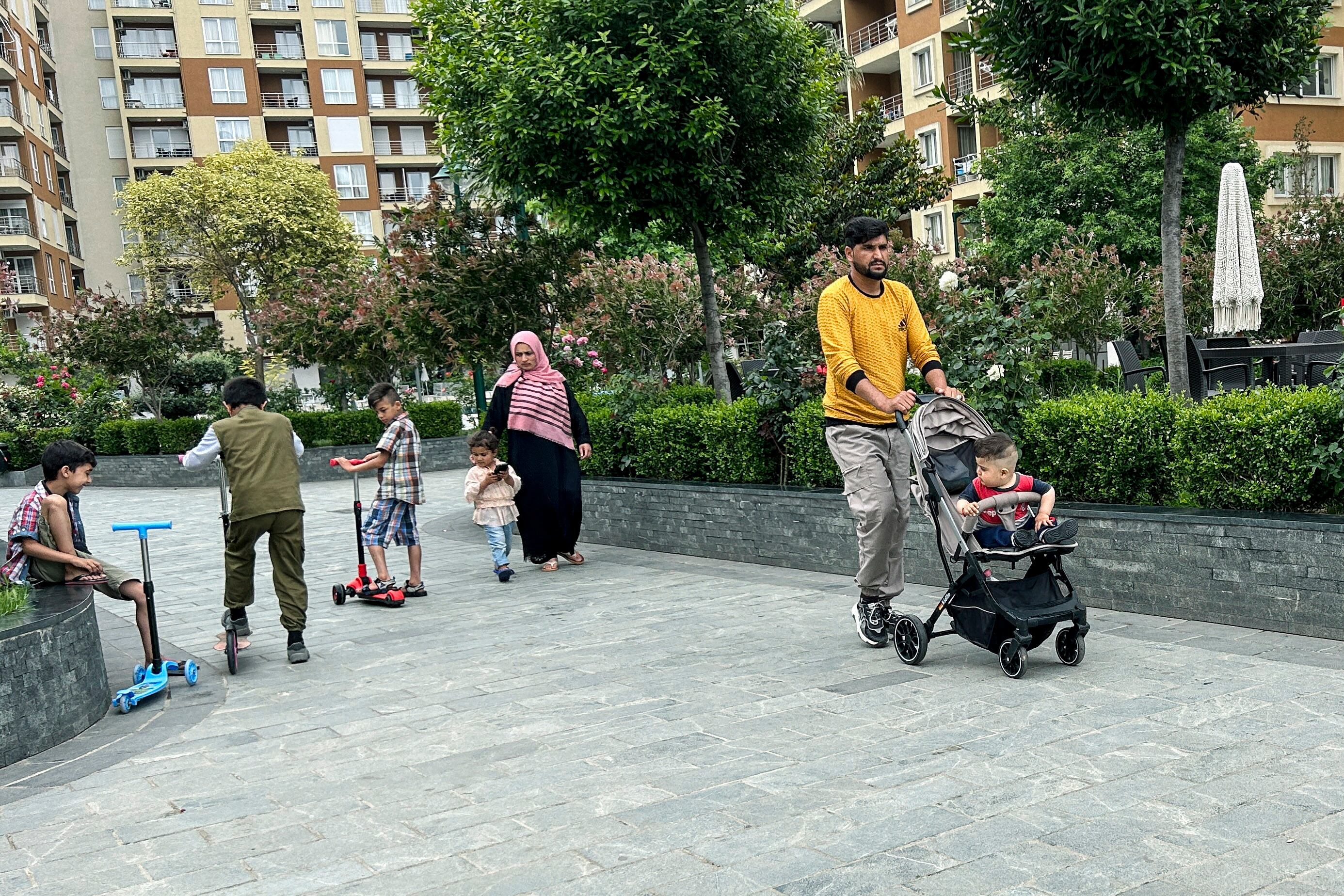 Afghans walk at a tourist resort where they are accommodated, in Shengjin, 44 miles northwest of the capital, Tirana, Albania, Tuesday, June 6, 2023.