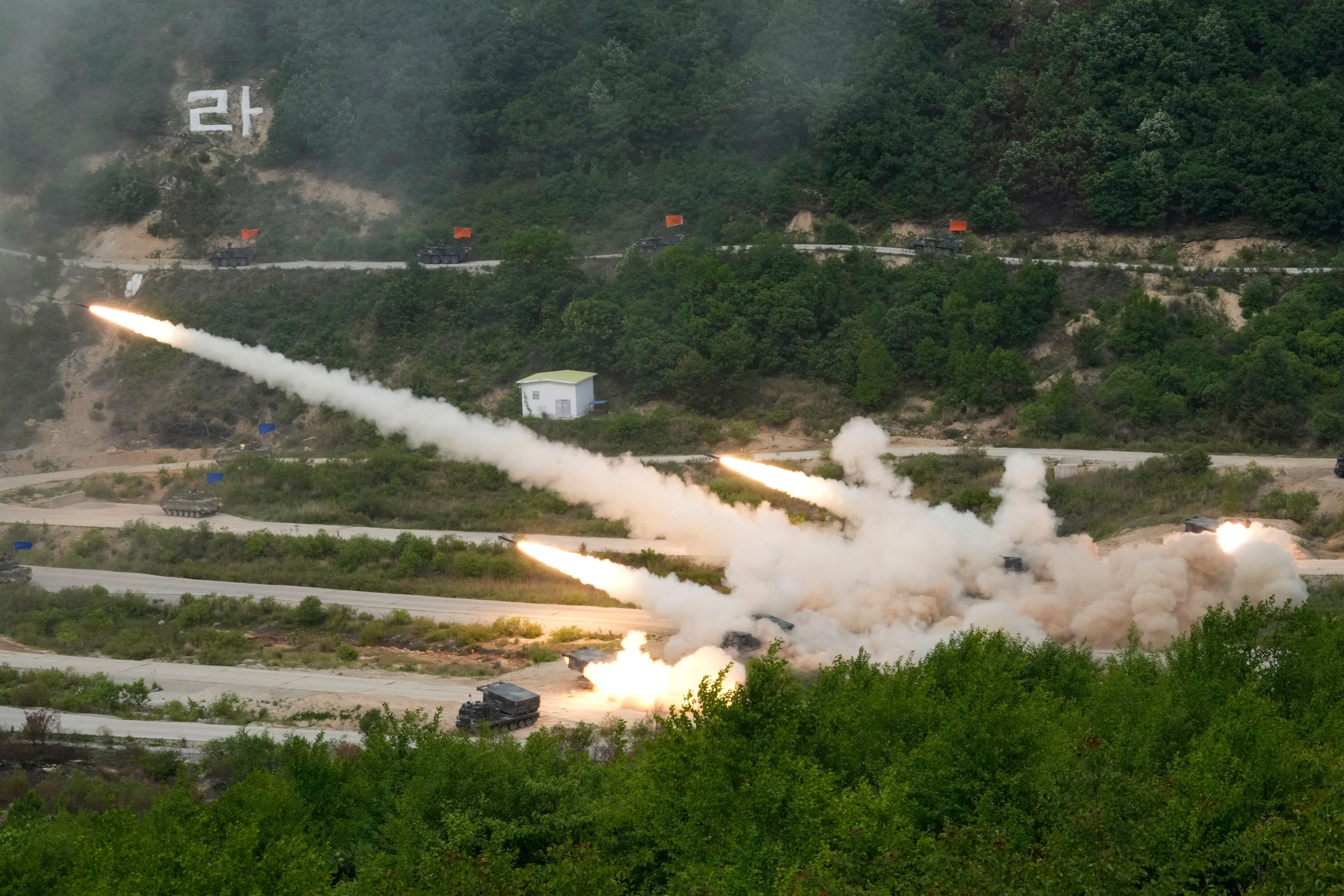 South Korean army's multiple launch rocket systems fire rockets during South Korea-U.S. joint military drills at Seungjin Fire Training Field in Pocheon, South Korea, Thursday, May 25, 2023.