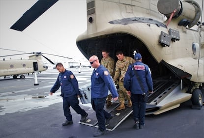 Soldiers practice loading and unloading operations on a CH-47F Chinook helicopter with helicopter search-and-rescue team members of Florida Task Force 1 at Opa-locka, Florida, on Sept. 28, 2022.