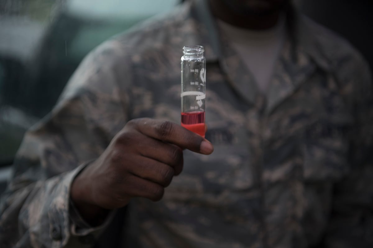 An airman tests water for chemicals at Barksdale Air Force Base, La.