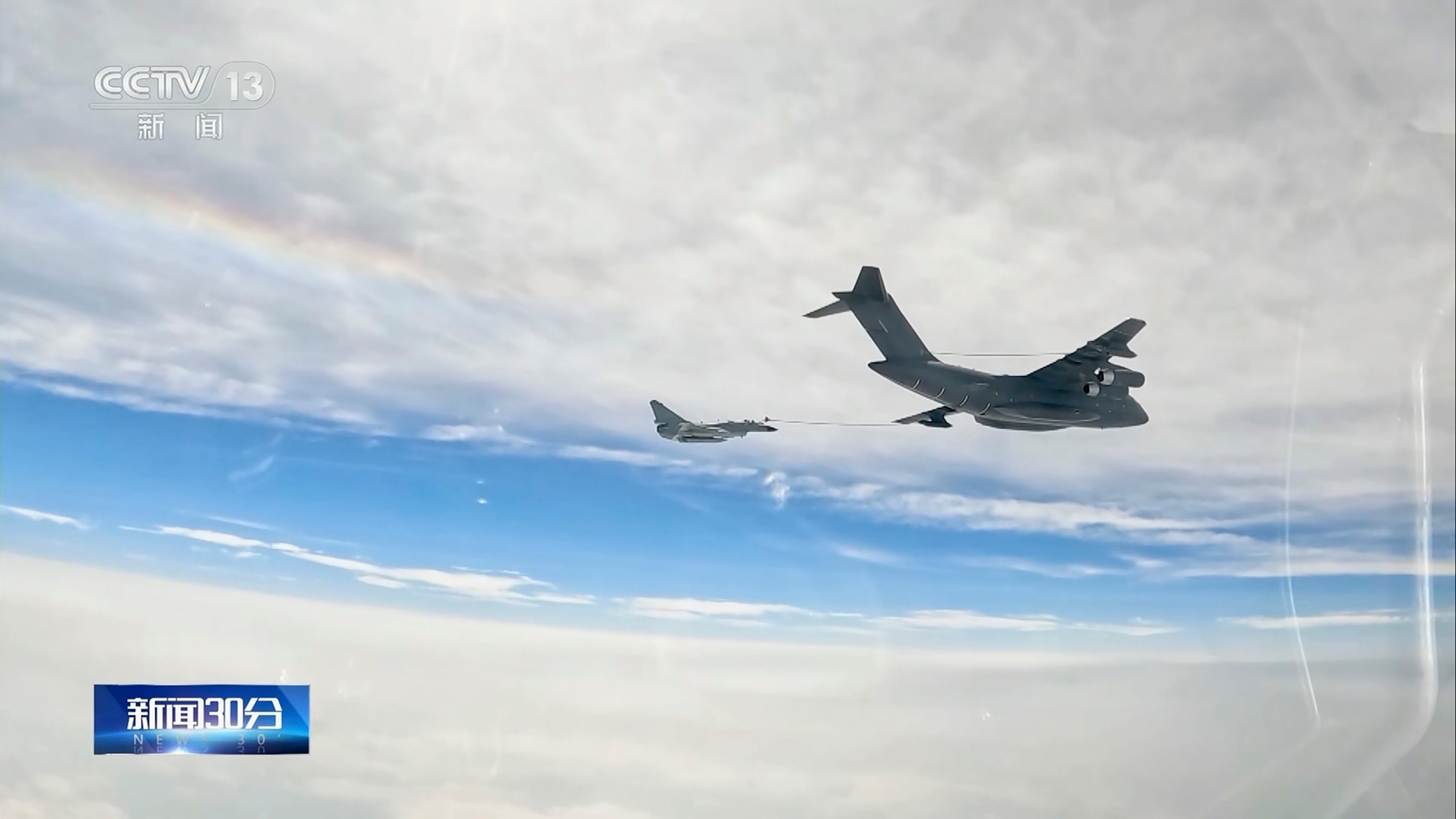 In this image taken from video footage run Saturday, April 8, 2023 by China's CCTV, a Chinese fighter jet performs an mid-air refueling maneuver at an unspecified location.