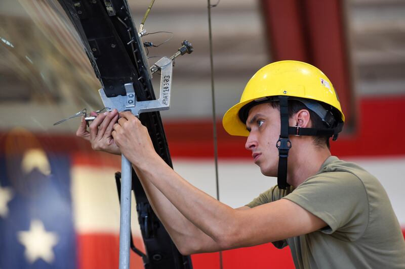 Senior Airman Andres Espinoza, 31st Maintenance Squadron egress journeyman, pins a canopy support strut on an F-16 Fighting Falcon <a href=