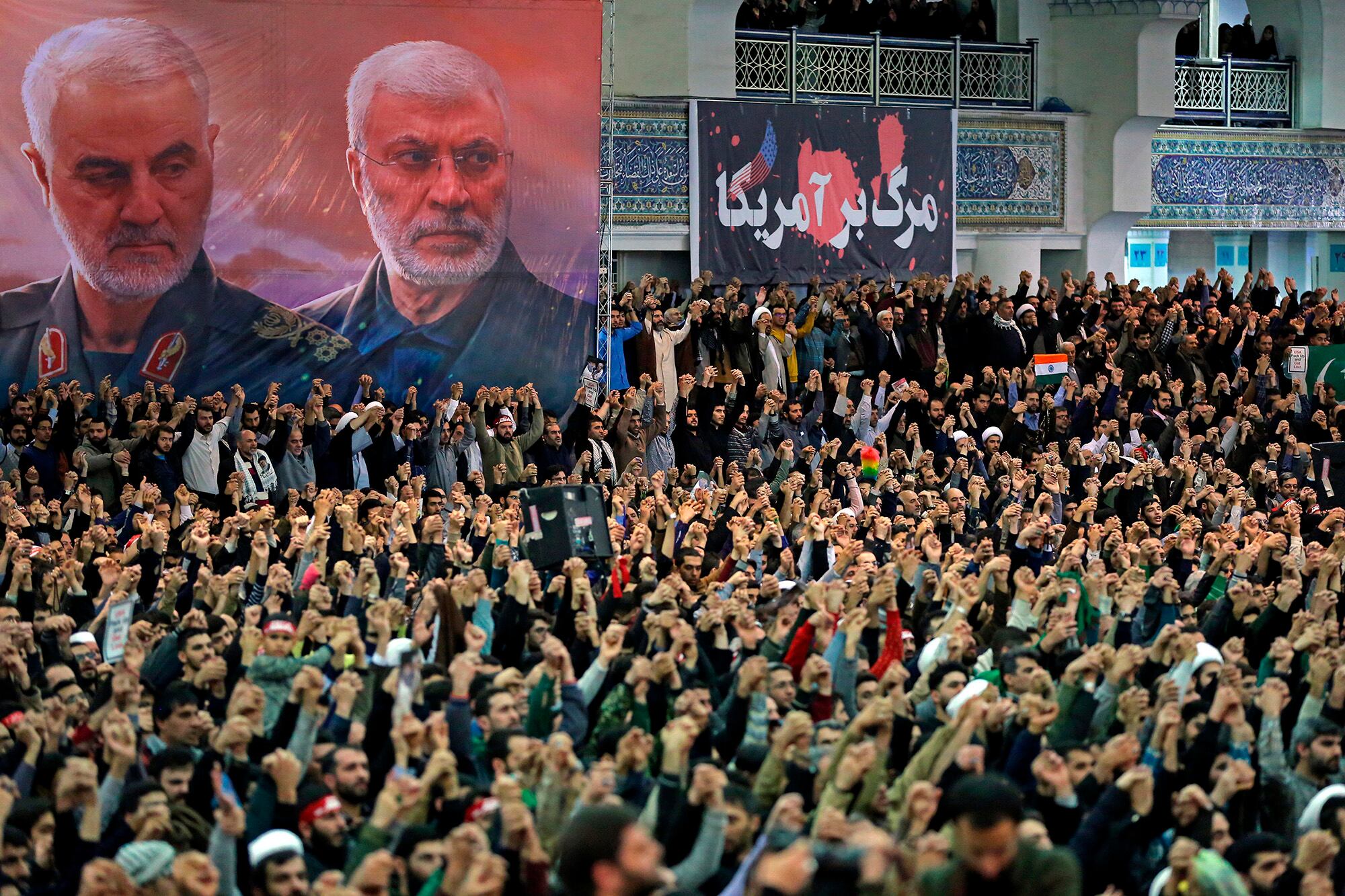 In this Jan. 17, 2020, file photo, released by the official website of the office of the Iranian supreme leader, worshippers chant slogans during Friday prayers ceremony, as a banner show Iranian Revolutionary Guard Gen. Qassem Soleimani, left, and Iraqi Shiite senior militia commander Abu Mahdi al-Muhandis, who were killed in Iraq in a U.S. drone attack on Jan. 3, and a banner which reads in Persian: "Death To America, "at Imam Khomeini Grand Mosque in Tehran, Iran.