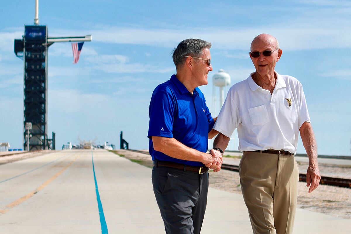 In this Tuesday, July 16, 2019 photo made available by NASA, astronaut Michael Collins, right, speaks to Kennedy Space Center Director Bob Cabana at Launch Complex 39A, about the moments leading up to launch at 9:32 a.m. on July 16, 1969, and what it was like to be part of the first mission to land on the moon.