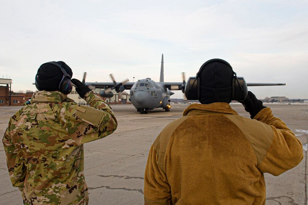 Col. Randy Stoeckmann, 934th Mission Support Group commander, left, and Col. Ken Rose, 934th Maintenance Group commander, right, salute deploying 934th Airlift Wing members at Minneapolis-St. Paul Air Reserve Station on Feb. 16,
2022. Airmen from the wing are deploying in support of a broader effort to demonstrate our commitment to our NATO allies. (Chris Farley/Air Force)