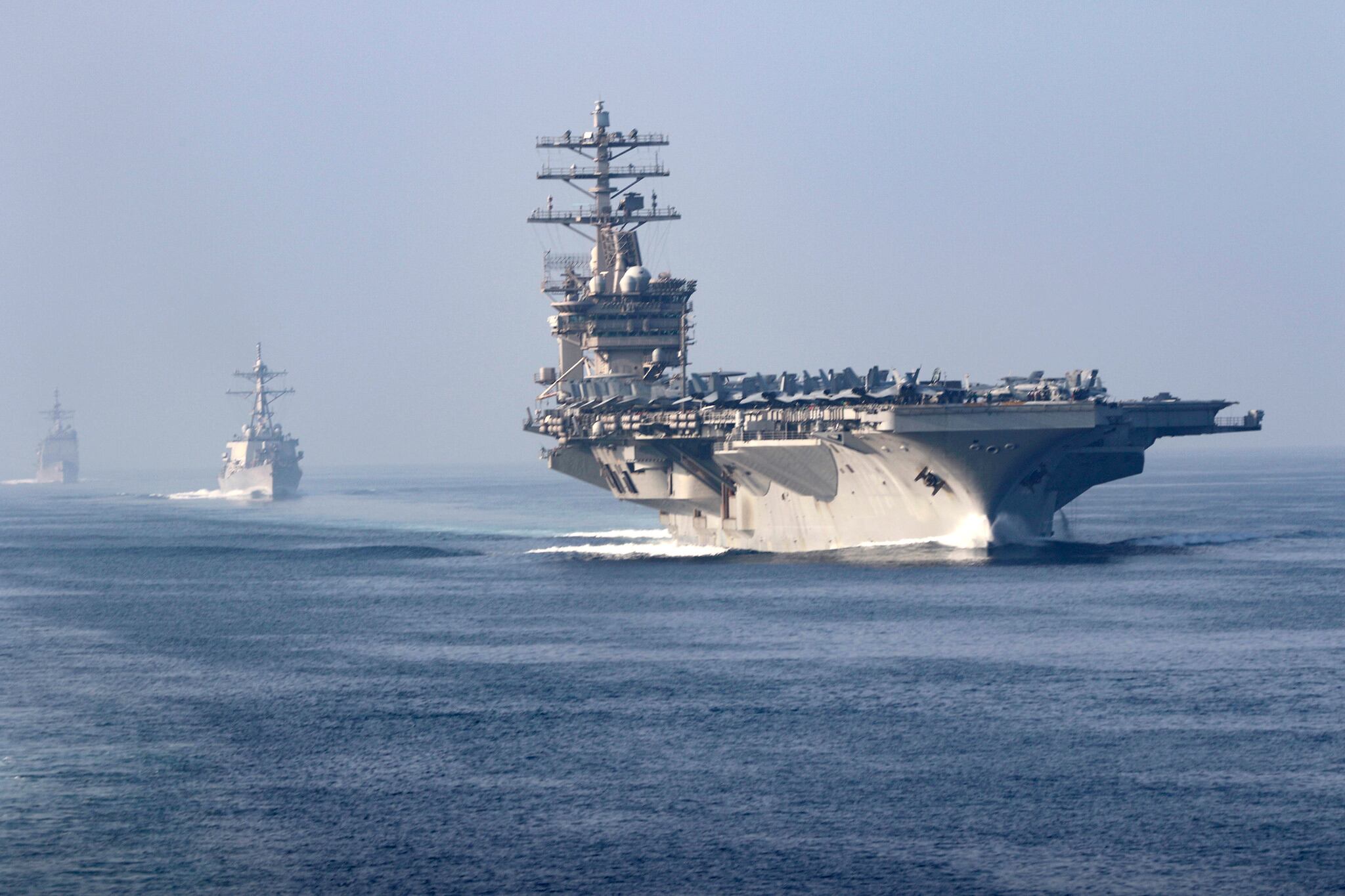 The aircraft carrier USS Nimitz (CVN 68), guided-missile destroyer USS John Paul Jones (DDG 53), center, and the guided-missile cruiser USS Princeton (CG 59) sail in formation during a scheduled transit of the Strait of Hormuz, Nov. 9, 2020.