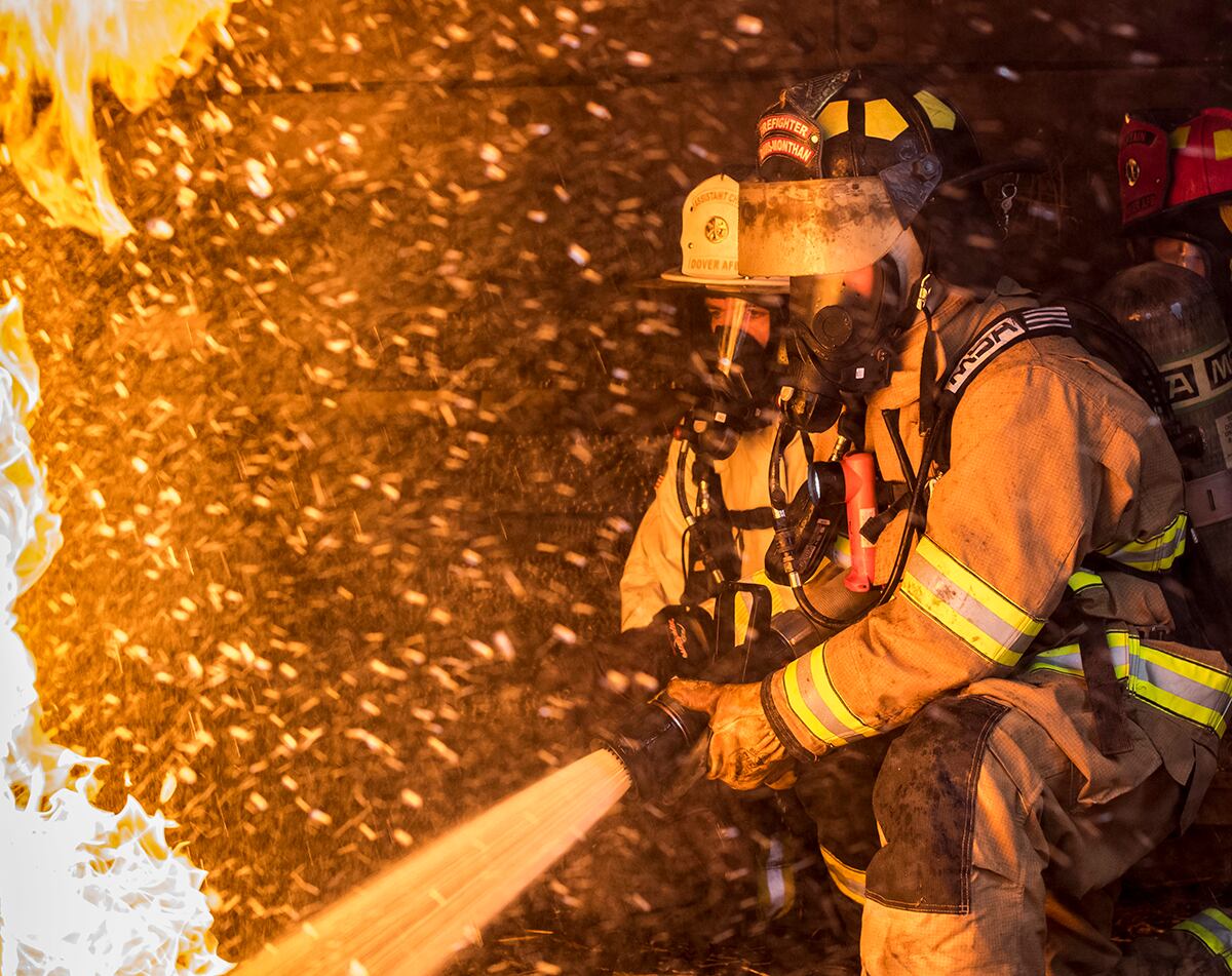 Firefighters extinguish flames in a controlled exercise at the structural burn training facility April 26, 2019, at Dover Air Force Base, Del.