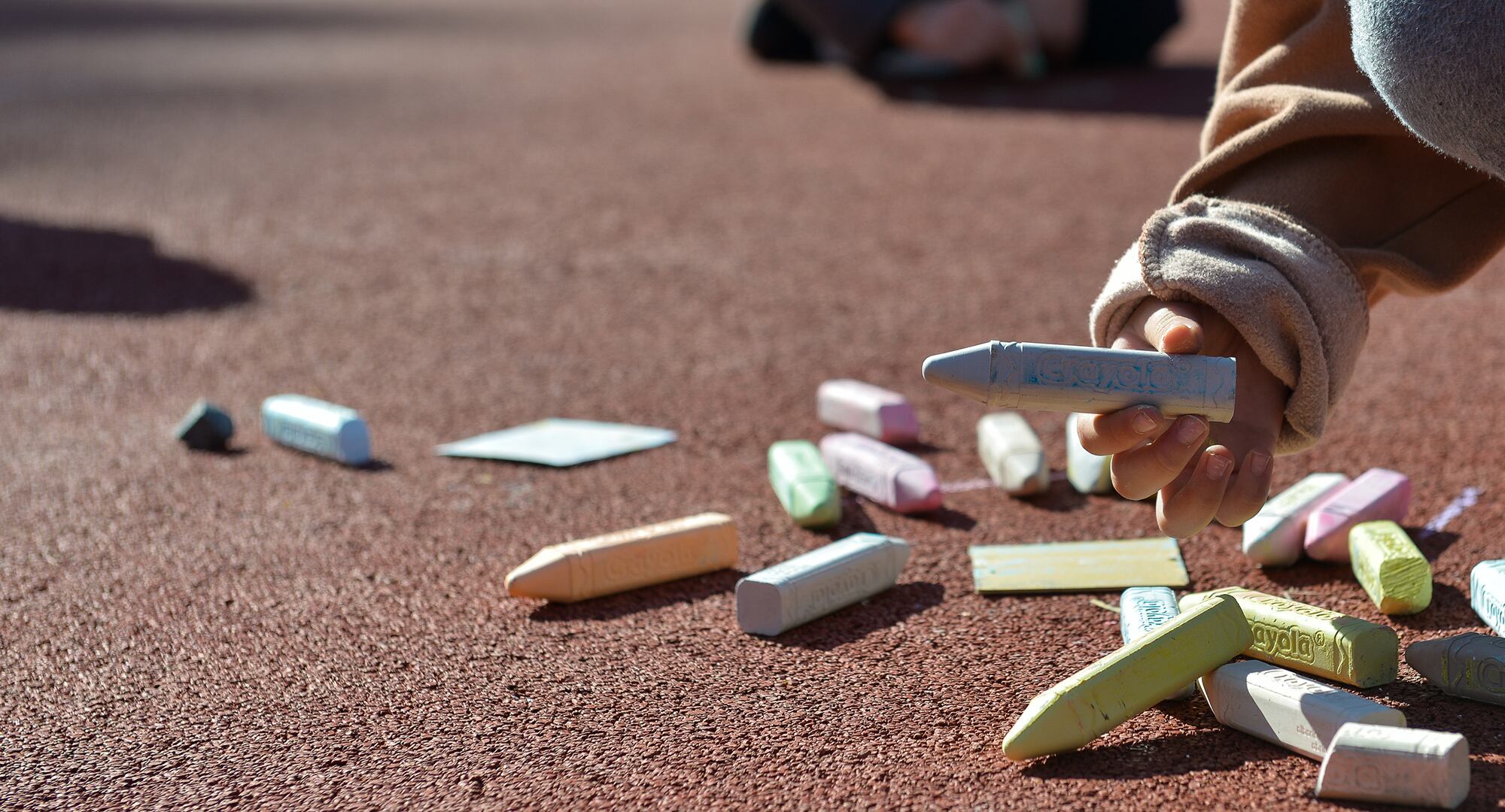 A child picks up a stick of chalk during a therapy session at Vogelweh Elementary School April 21, 2016, at Vogelweh Military Complex, Germany.