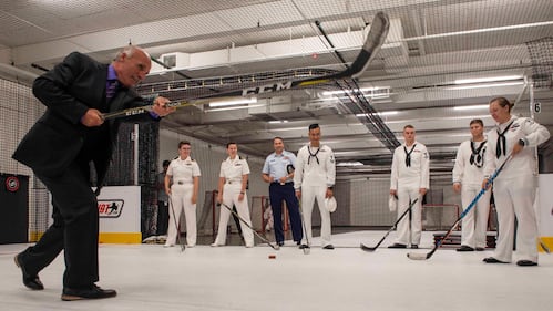 Daryl Evans, LA Kings alumni and commentator, teaches sailors assigned to the guided missile-destroyer USS Spruance (DDG 111) how to shoot a hockey puck Aug. 29, 2019, while touring Toyota Sports Center during Los Angeles Fleet Week.