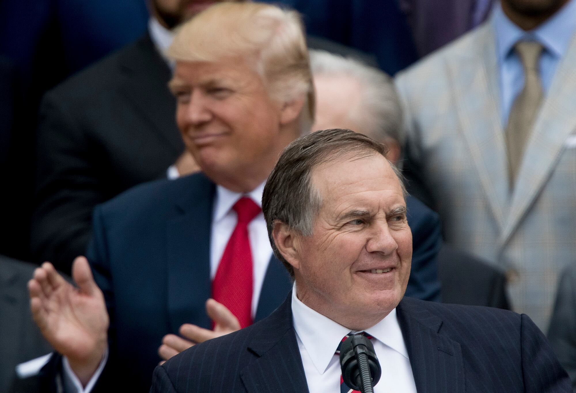 President Donald Trump listens as New England Patriots head coach Bill Belichick speaks during a ceremony on the South Lawn of the White House in Washington, Wednesday, April 19, 2017, where the president honored the Super Bowl Champion New England Patriots for their Super Bowl LI victory.