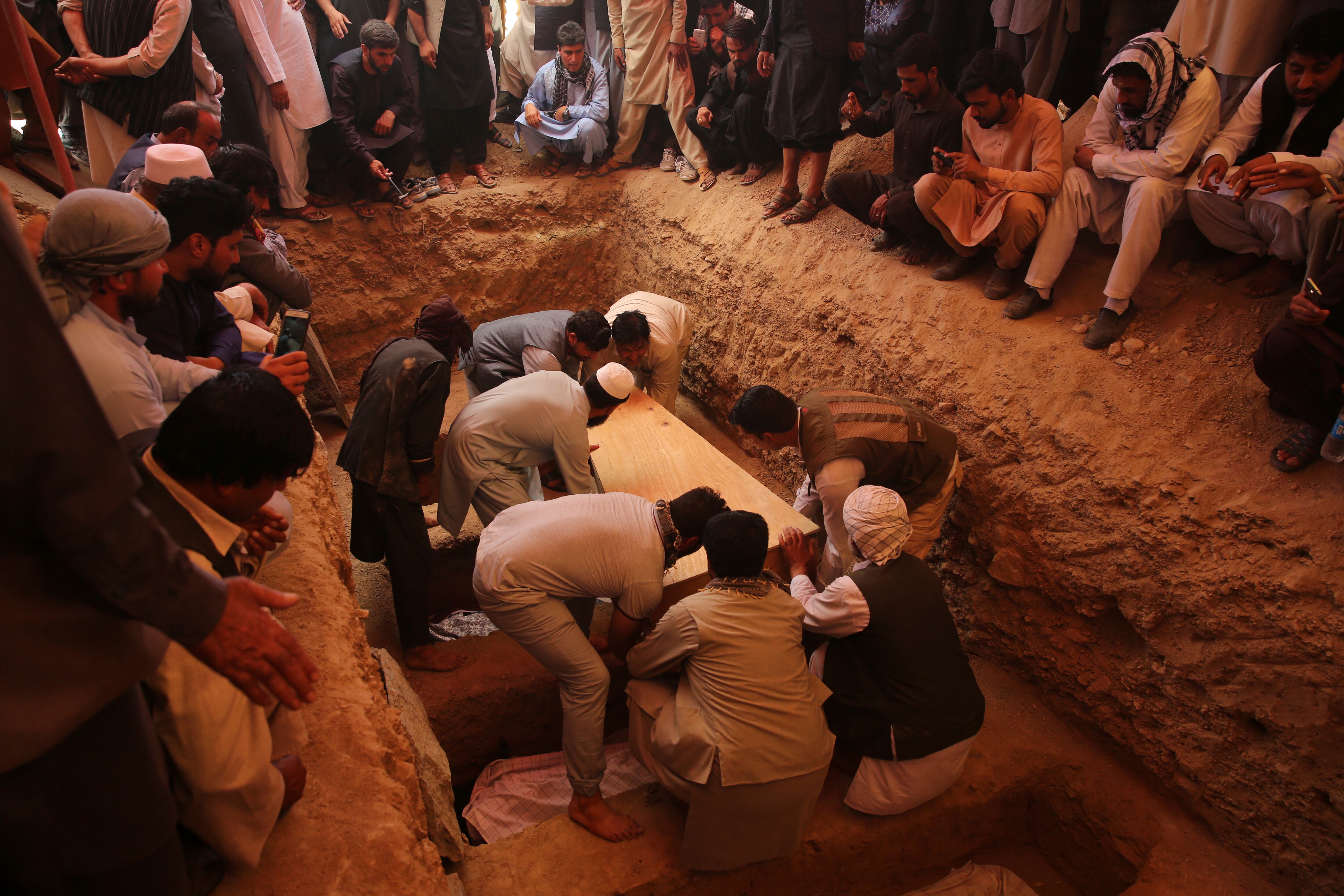 Afghans bury the bodies of victims of the Dubai City wedding hall bombing during a mass funeral in Kabul, Afghanistan, Sunday, Aug.18, 2019.