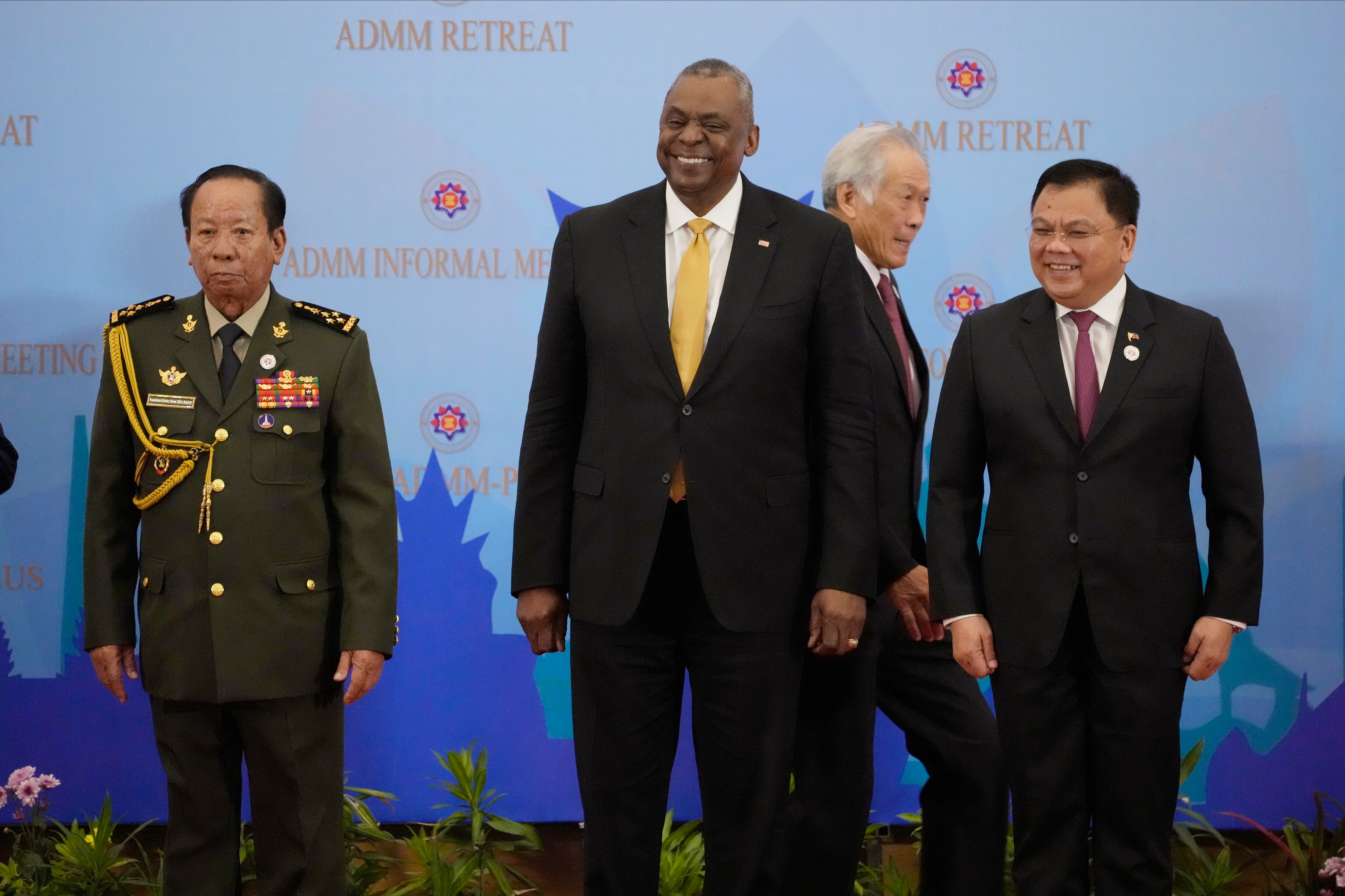 U.S. Secretary of Defense Lloyd J. Austin III, center, poses for a group photo together with Cambodia's Defense Minister Tea Banh, left, Philippines Senior Undersecretary Jose Faustino Jr., right, as Singapore Defense Minister Ng Eng Hen walks at the venue of the Association of Southeast Asian Nations (ASEAN) during the ASEAN-United State Defense Ministers' Informal Meeting in Siem Reap, Cambodia, Tuesday, Nov. 22, 2022.