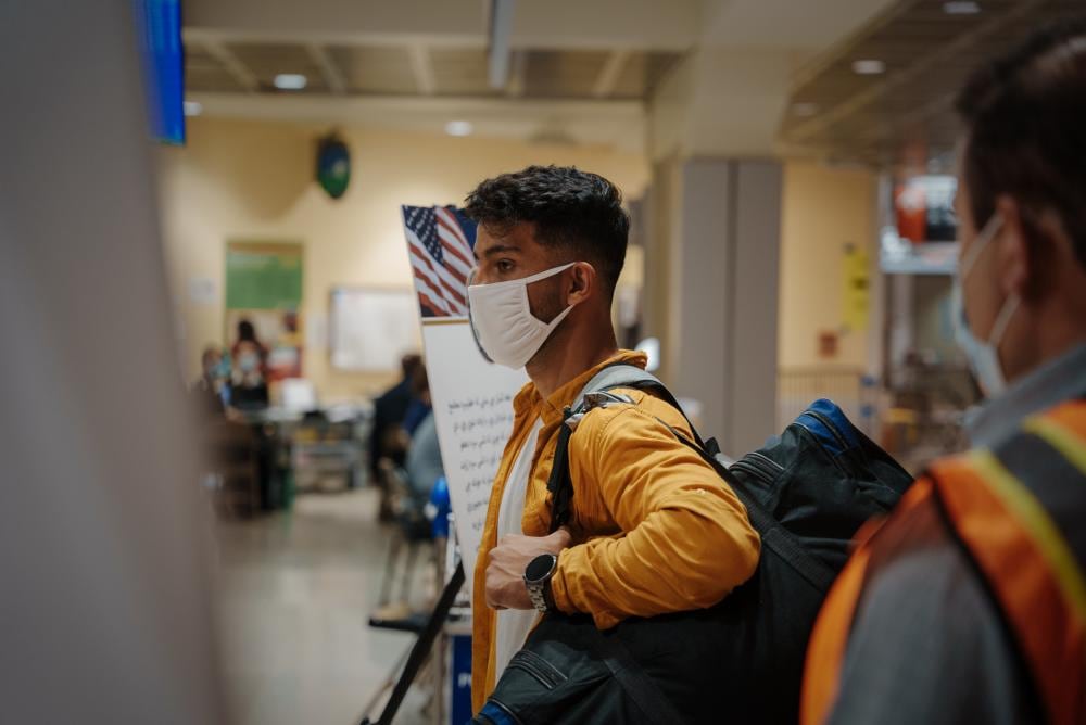 An Afghan individual waits to be processed at the Philadelphia International Airport, Philadelphia, Pennsylvania, Oct. 5, 2021. The person is part of a group traveling to Fort Pickett, Virginia, to begin their resettlement process into the United States. The Department of Defense, through U.S. Northern Command, and in support of the Department of Homeland Security, is providing transportation, temporary housing, medical screening, and general support for at least 50,000 Afghan evacuees at suitable facilities, in permanent or temporary structures, as quickly as possible. (Cpl. Corey Mathews/Marine Corps)