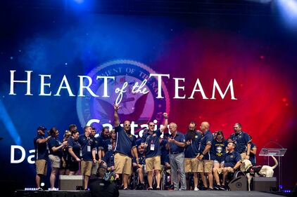 Coast Guard Capt. Daryl Schaffer, center, celebrates with Team Navy after being awarded the Heart of the Team award on June 30 during the closing ceremony of the 2019 DoD Warrior Games in Tampa, Fla.