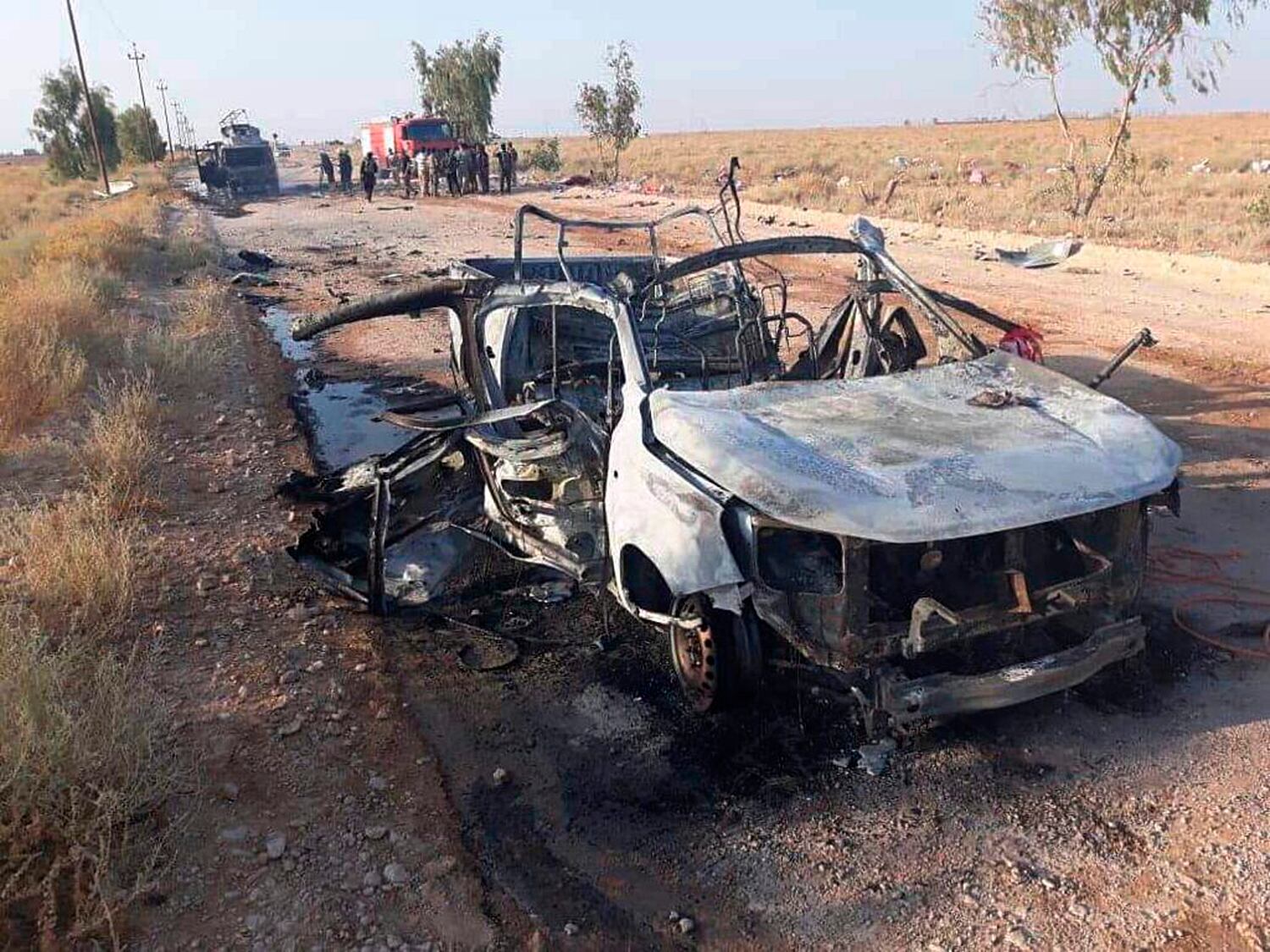 This photo released by Popular Mobilization Forces shows shows the aftermath of a drone attack near Qaim border crossing with Syria, in Anbar province