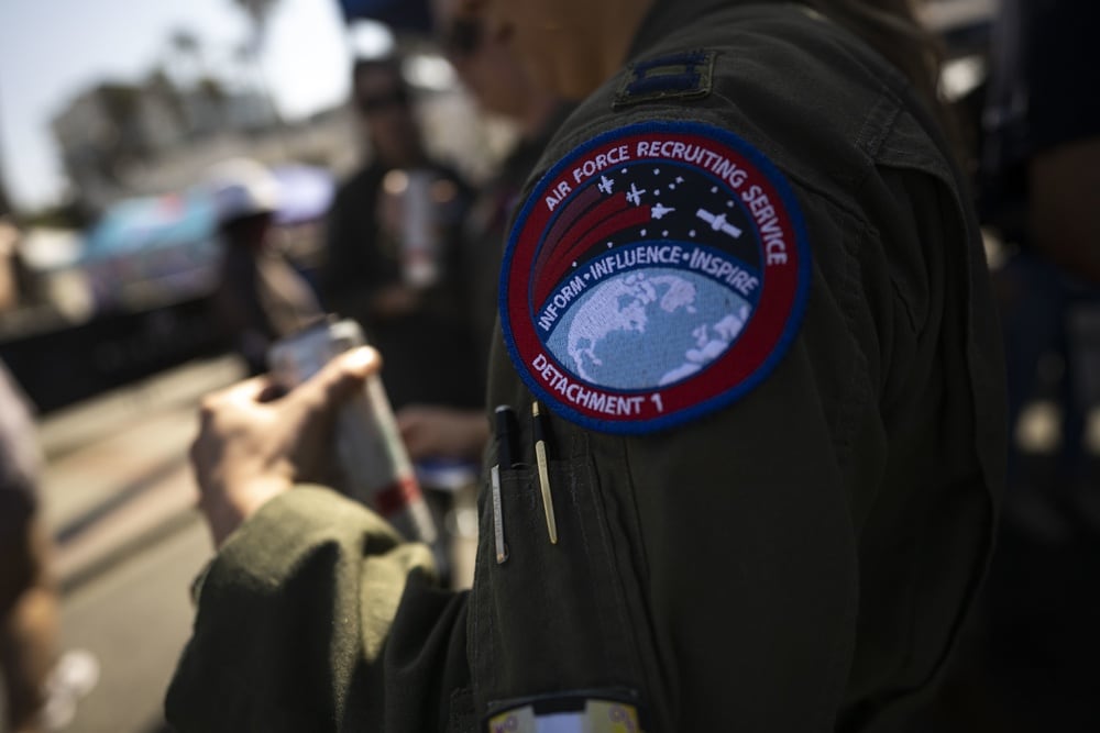 Members of Air Force Recruiting Service Detachment 1 interact with guests of the Super Girl Pro surfing event, Oceanside, Calif., on Sept. 18, 2021. The 14th annual Super Girl Surf Pro is a 3-day competition featuring the top professional female athletes from around the world. The U.S. Air Force is a partnered sponsor of the event, making a priority to inspire and empower girls and women of all ages. (Tech. Sgt. Erik Cardenas/Air Force)