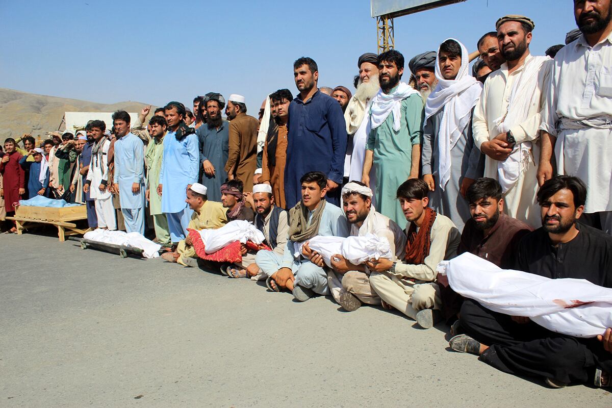 Residents carry bodies of those who were killed in an airstrike during a protest in Baghlan province, northern Afghanistan, Tuesday, July 9, 2019.