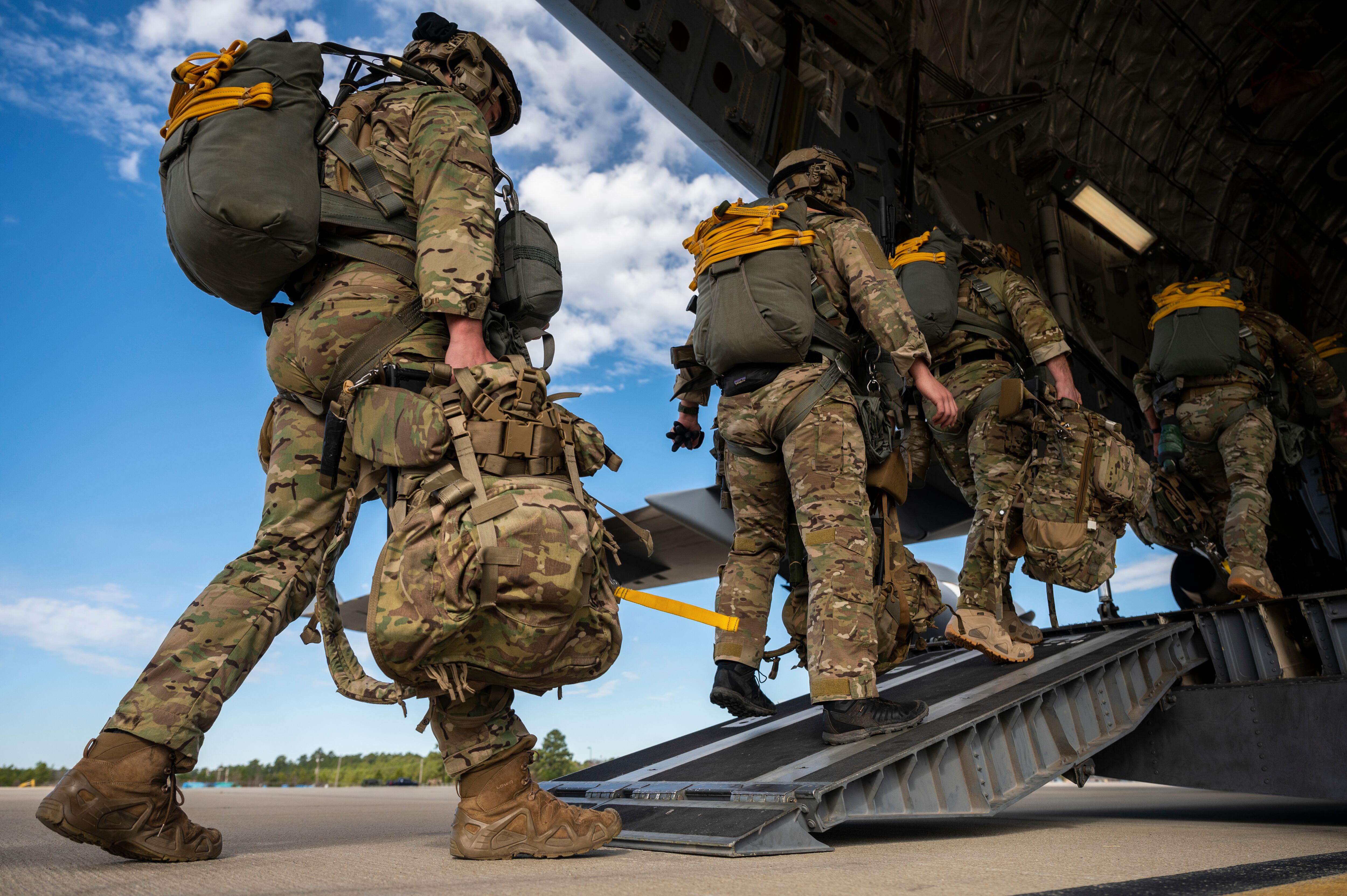 Special tactics airmen walk onto a C-17 cargo plane