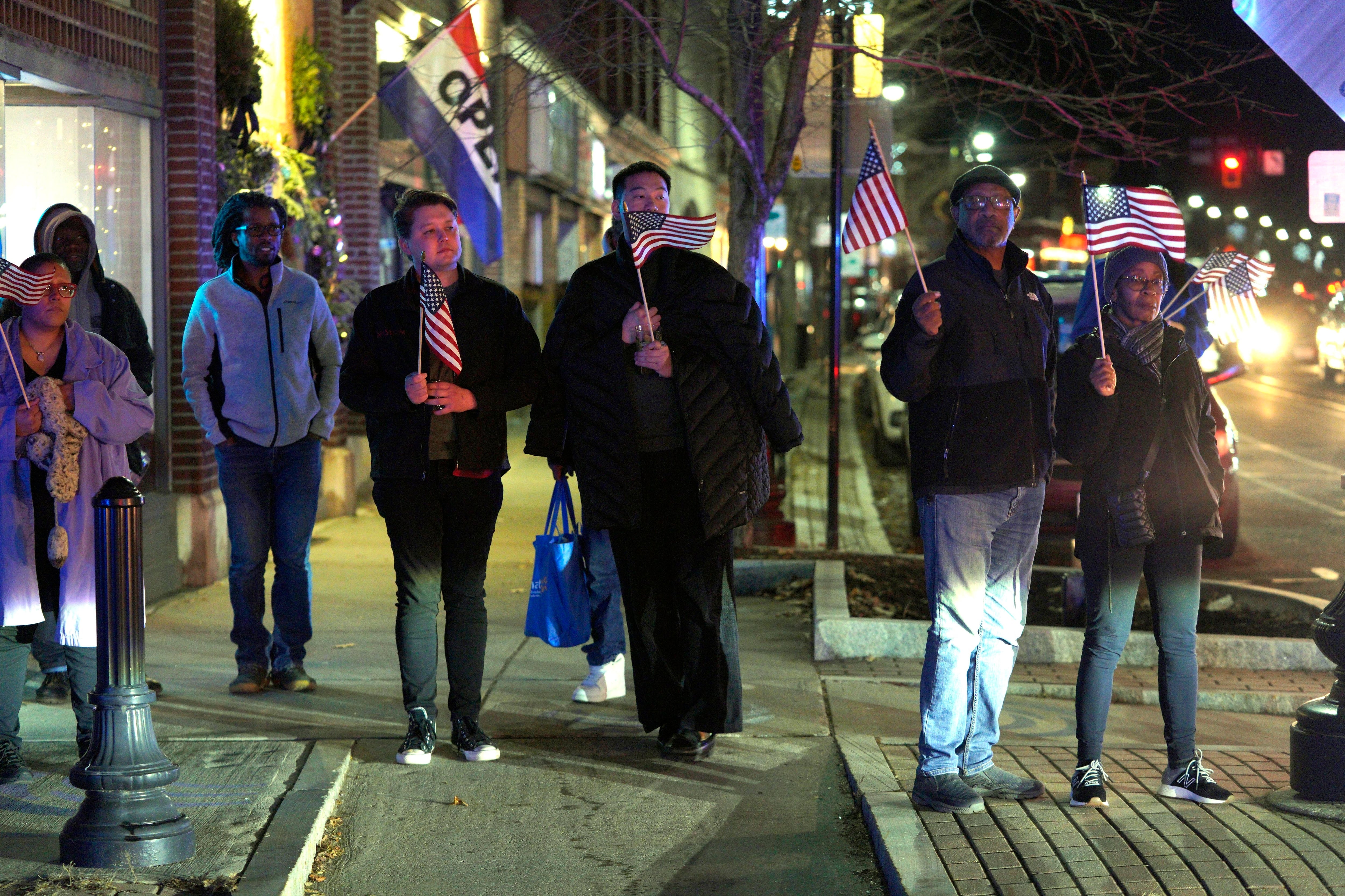 Solemn onlookers lined North Street to witness the return of Staff Sgt. Jake Galliher, Friday, Dec. 15, 2023 in Pittsfield, Mass.