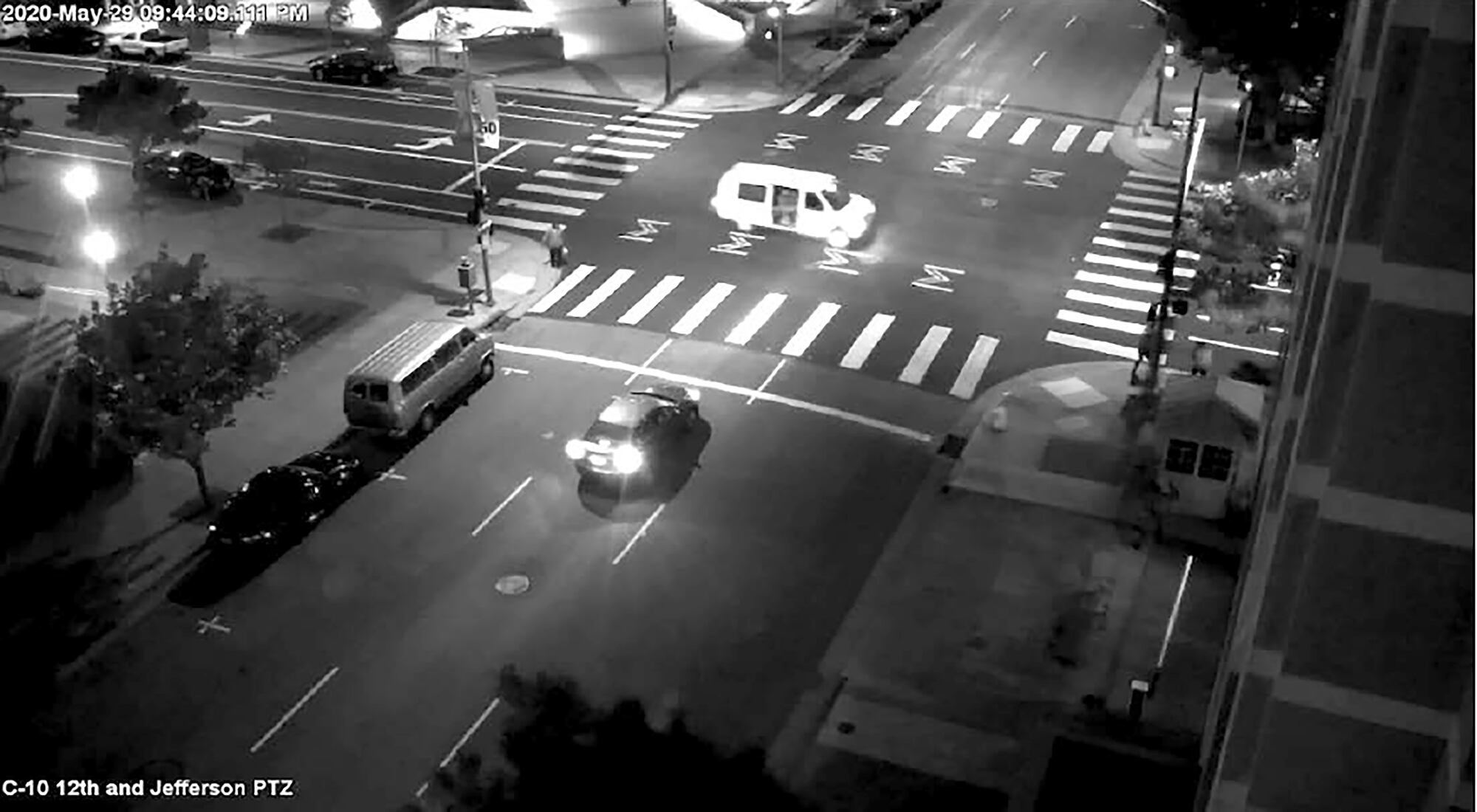 This May 29, 2020, surveillance photo provided by the FBI shows a van with the passenger side door open as someone fires at a security kiosk at the Ronald V. Dellums Federal Building in Oakland, Calif.