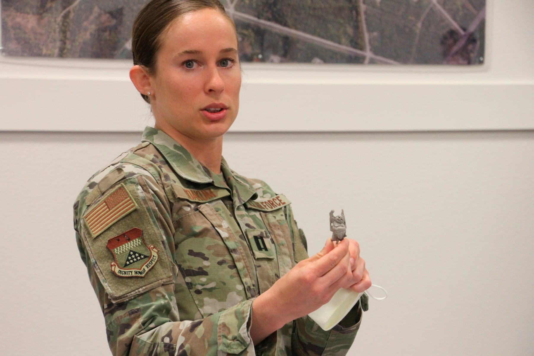 Air Force Capt. Shelby Yoakum shows a lucky Buddha figurine on June 26, 2020, at Joint Base Elmendorf-Richardson, Alaska