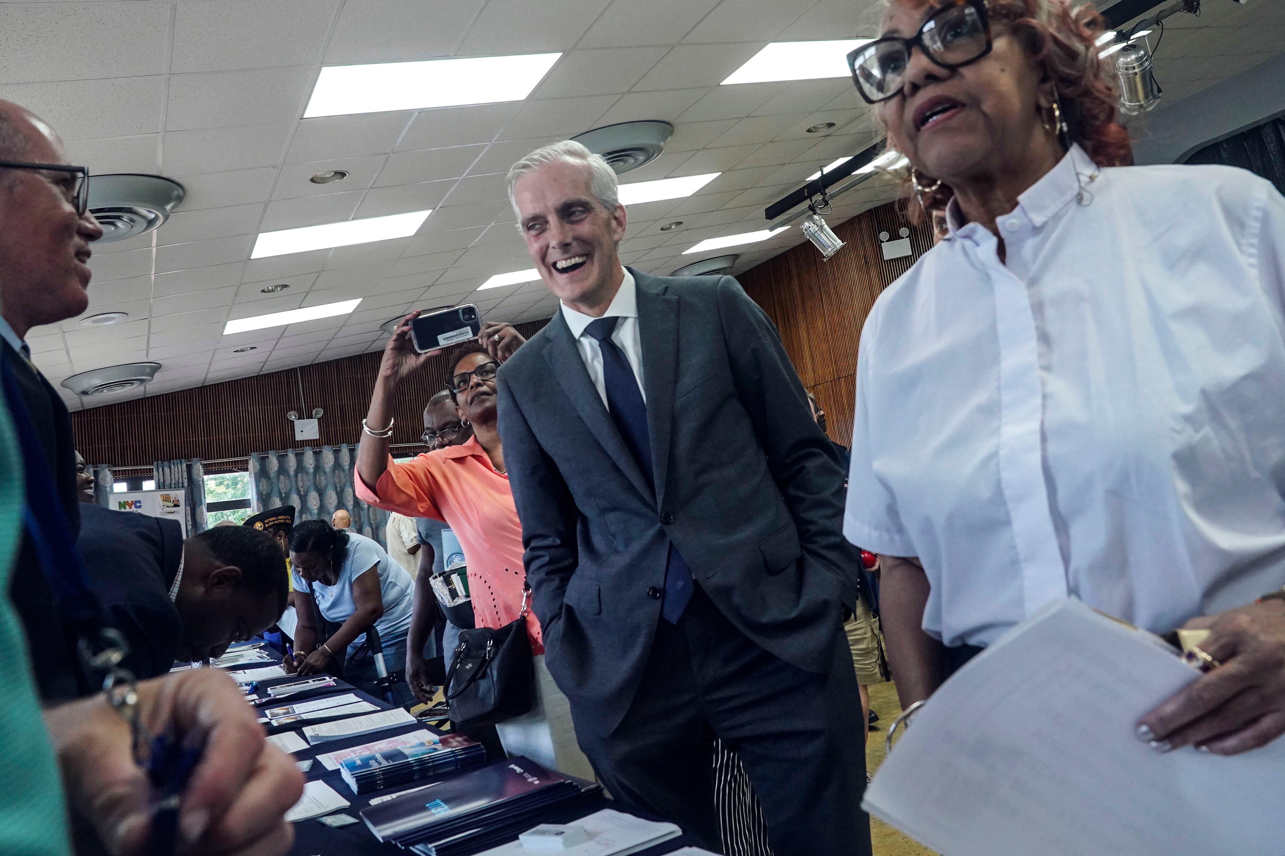 Veterans Affairs Secretary Denis McDonough, center, meets with attendees at a resource fair for veterans and survivors to apply for benefits under the PACT Act, Wednesday Aug. 2, 2023, in New York.