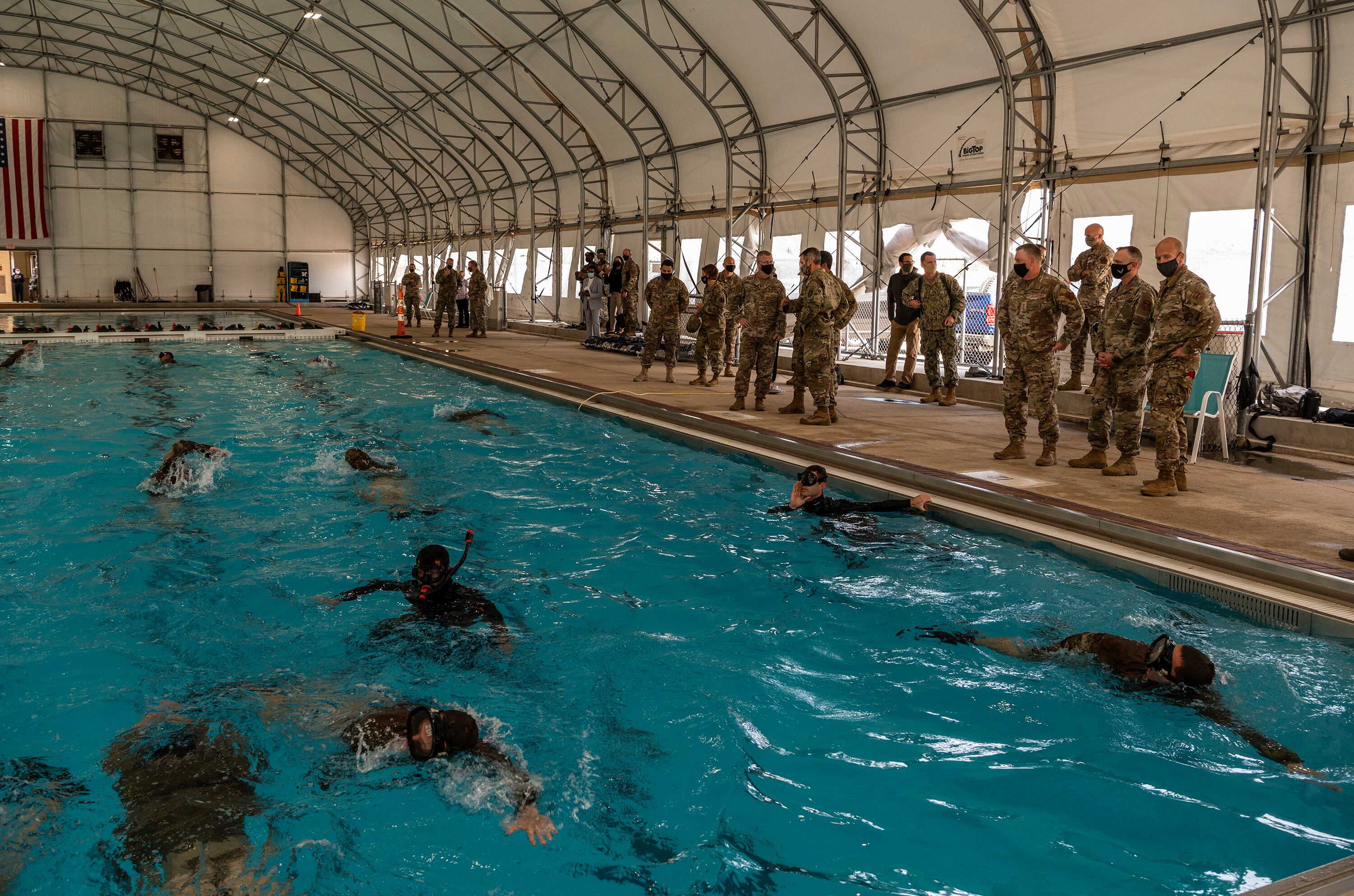 Army Gen. Richard D. Clarke, commander of U.S. Special Operations Command, at MacDill Air Force Base, Fla. and U.S. Air Force Chief Master Sgt. Gregory Smith, USSOCOM command chief (both center-right), listen to a brief during a tour of the Special Warfare Training Wing's water confidence drill Oct. 16, 2020, at Joint Base San Antonio-Lackland, Texas. (Johnny Saldivar/Air Force)