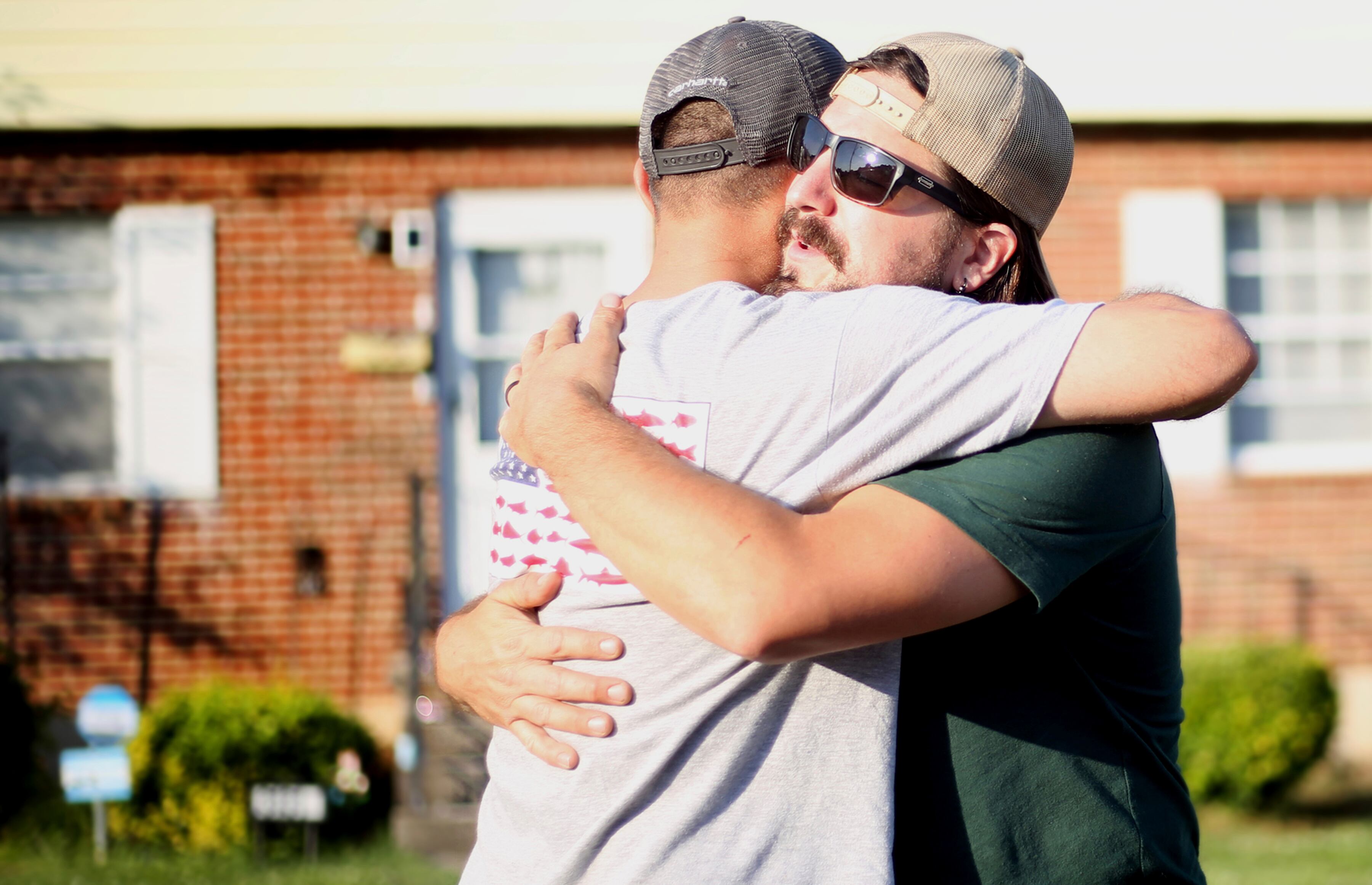 Tashmorad Qara, left, and Andreas Panagore share a moment after catching up over a traditional Afghan meal, prepared by Qara, on May, 17, 2023, in Roanoke, Va.