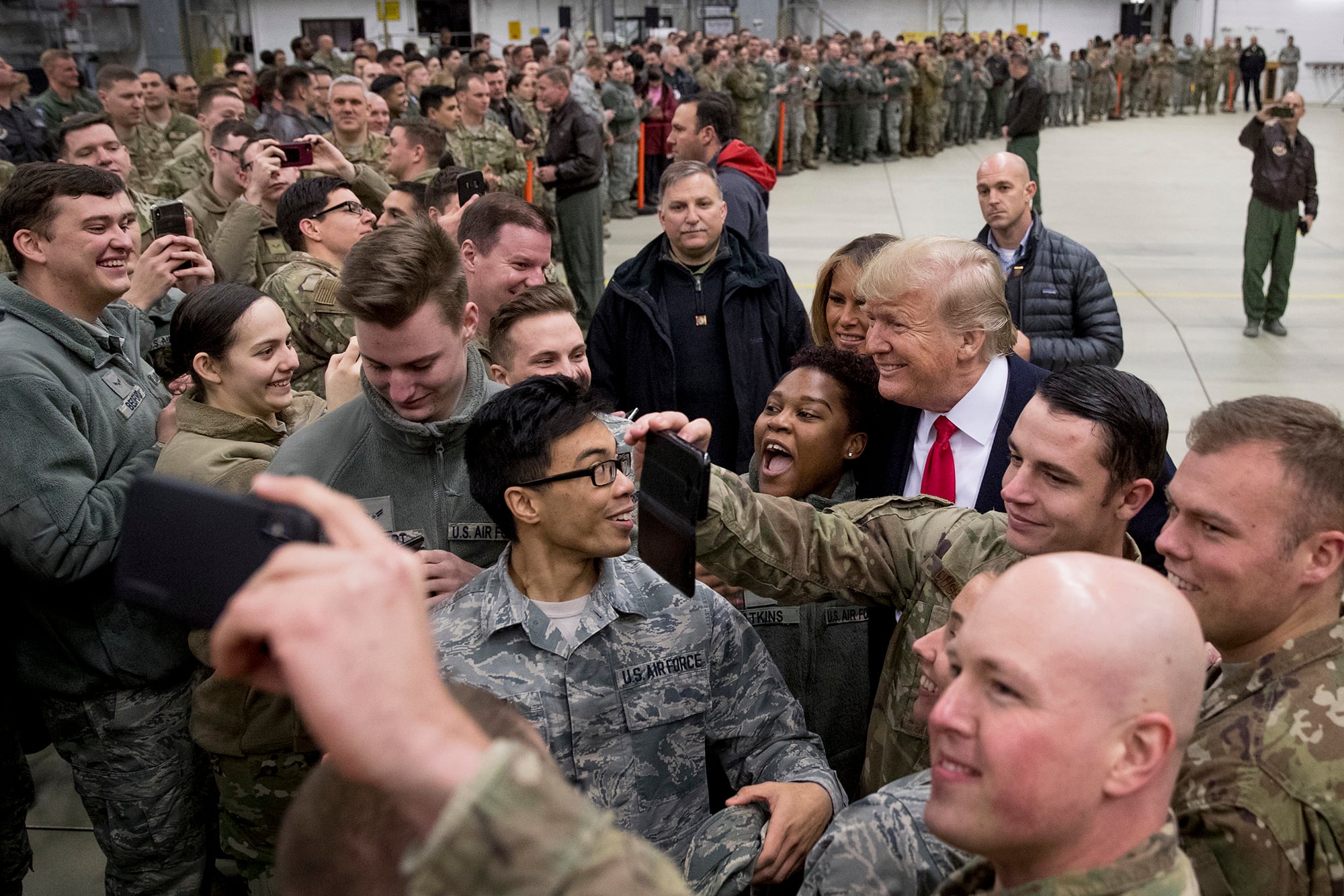 In this Dec. 27, 2018, file photo, President Donald Trump, center right, and first lady Melania Trump, center left, greet members of the military at Ramstein Air Base, Germany.