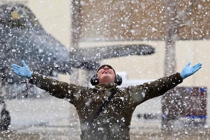 A U.S. Air Force crew chief enjoys the snow at Davis-Monthan Air Force Base, Ariz., Jan. 26, 2021. The last time it snowed at Davis-Monthan was approximately two years ago, so the snow was a surprise for maintainers working the flightline.