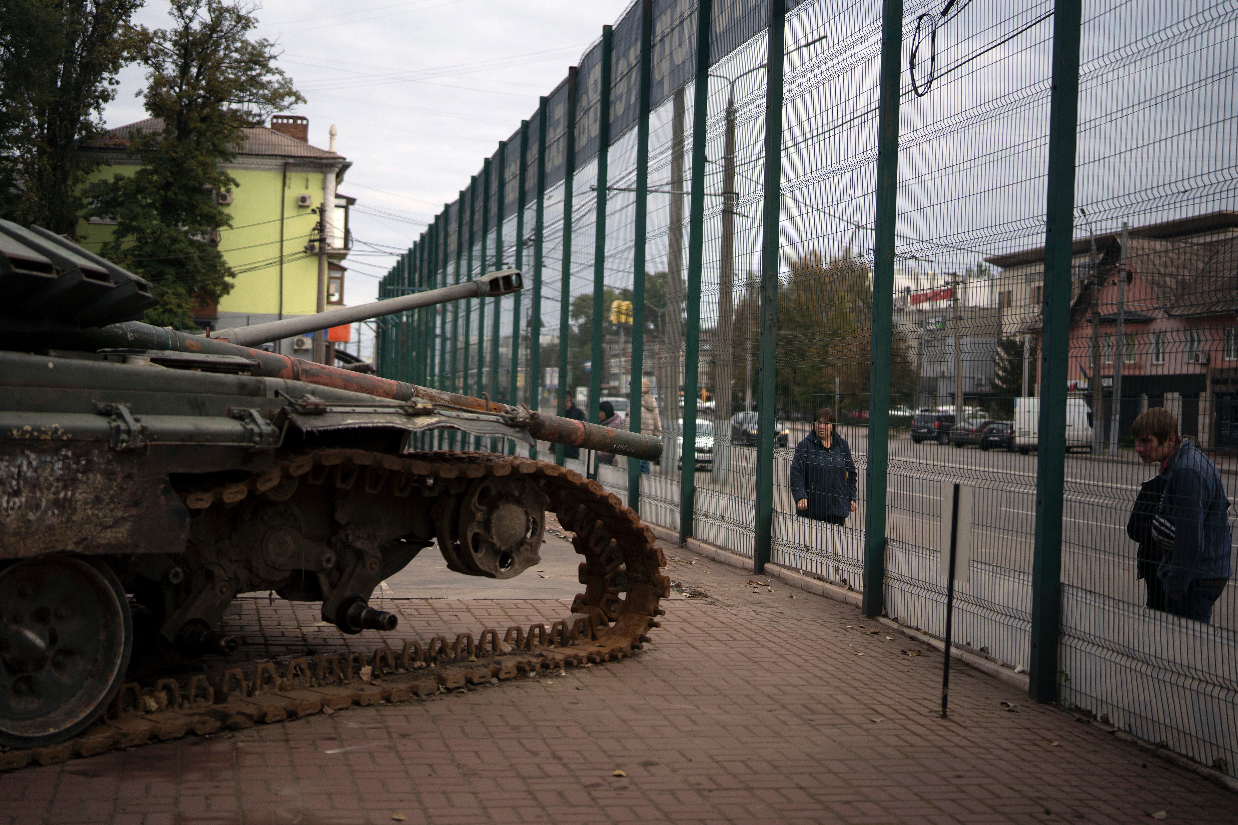 People look at a display of destroyed Russian military vehicles during the Defender of Ukraine Day in Kryvyi Rih, Ukraine, Friday, Oct. 14, 2022.