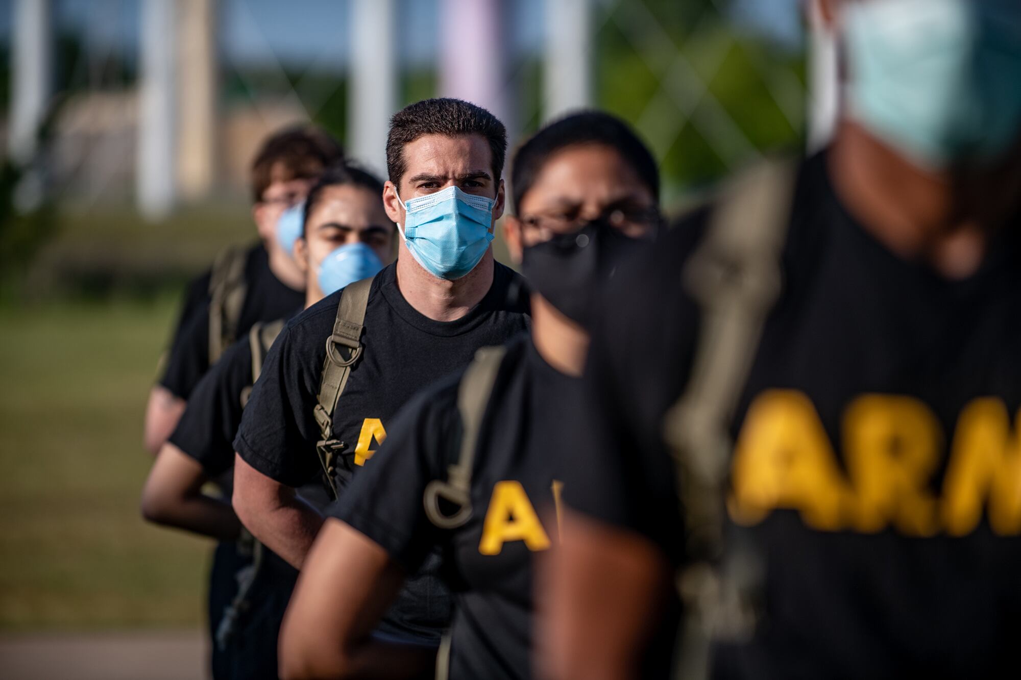 Soldiers from 95th Adjutant General Battalion, 434th Field Artillery Brigade, Fort Sill, Okla., stand in formation while wearing masks and maintaining physical distancing during reception before entering basic combat training May 14, 2020, on Fort Sill.