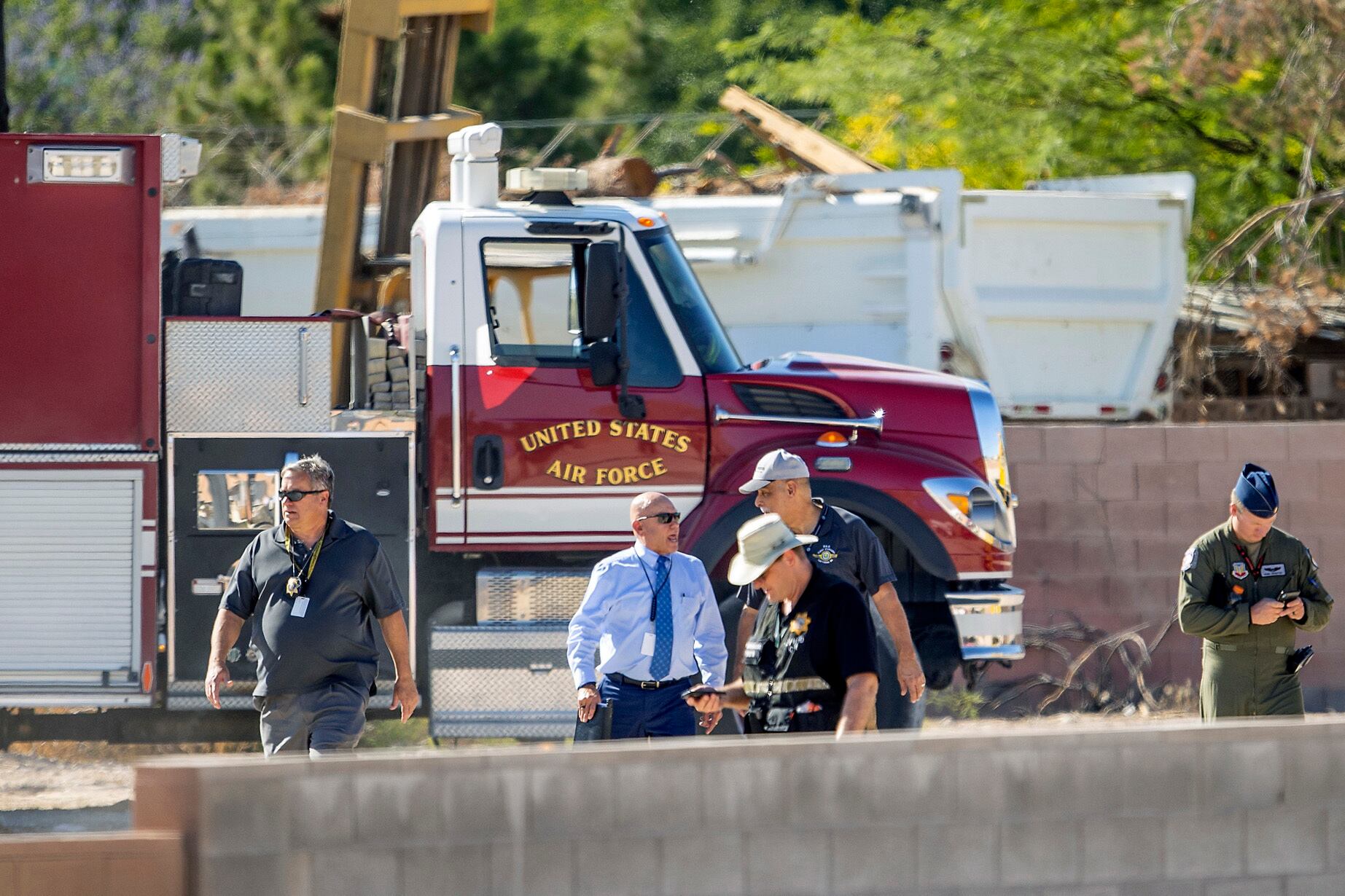 n front of an emergency vehicle, first responders investigate at the scene of an airplane crash.