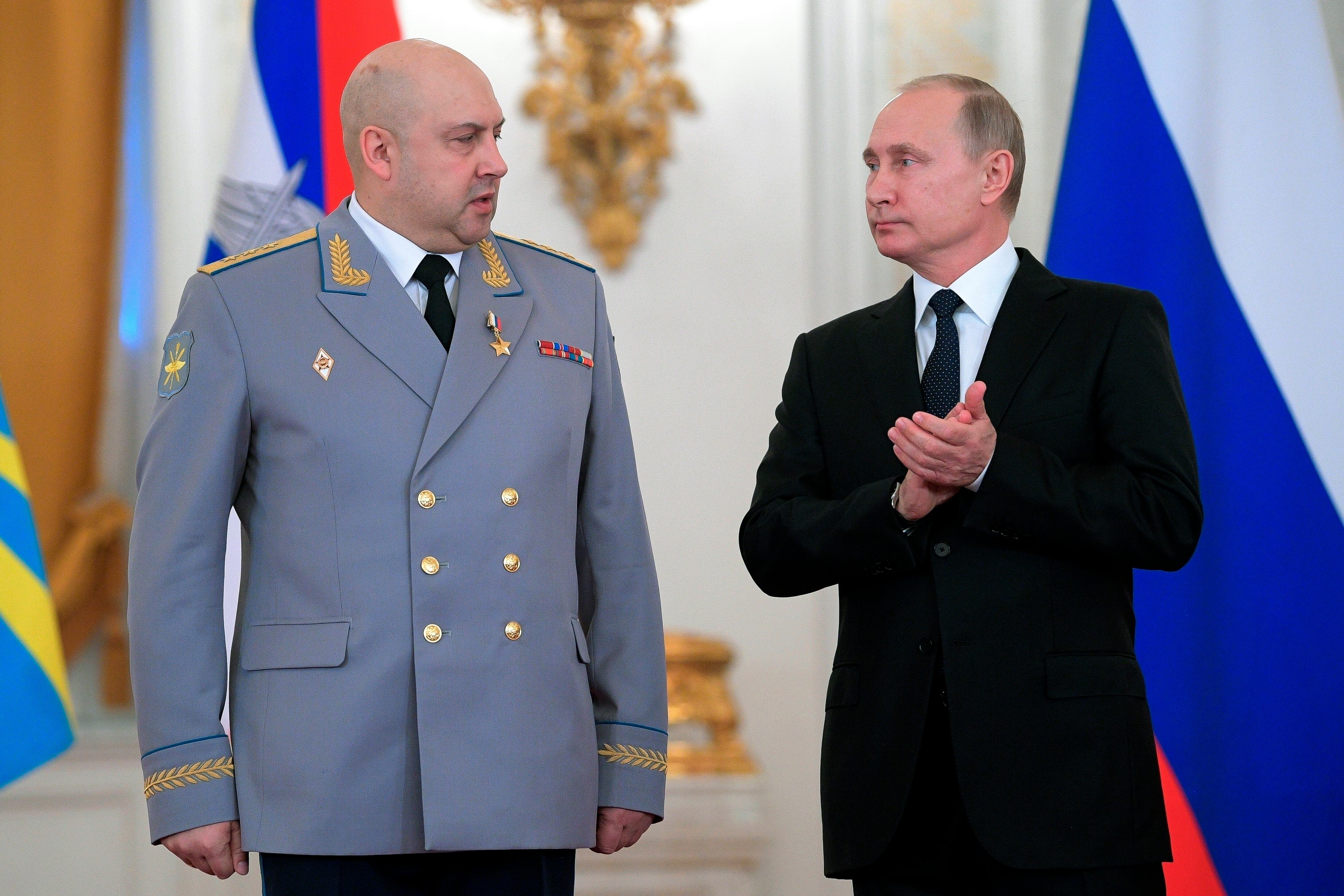 Russian President Vladimir Putin, right, applauds Col. Gen. Sergei Surovikin during an awards ceremony for troops who fought in Syria, in the Kremlin, in Moscow, Russia, Dec. 28, 2017.