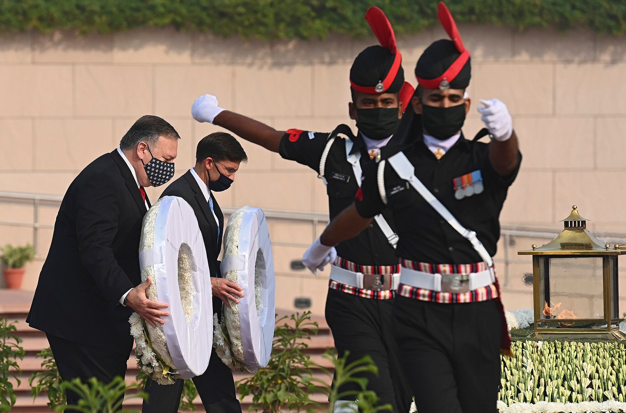 U.S. Secretary of State Mike Pompeo, left, and Secretary of Defense Mark Esper pay their tributes at the National War Memorial in New Delhi, India, Tuesday, Oct. 27, 2020.